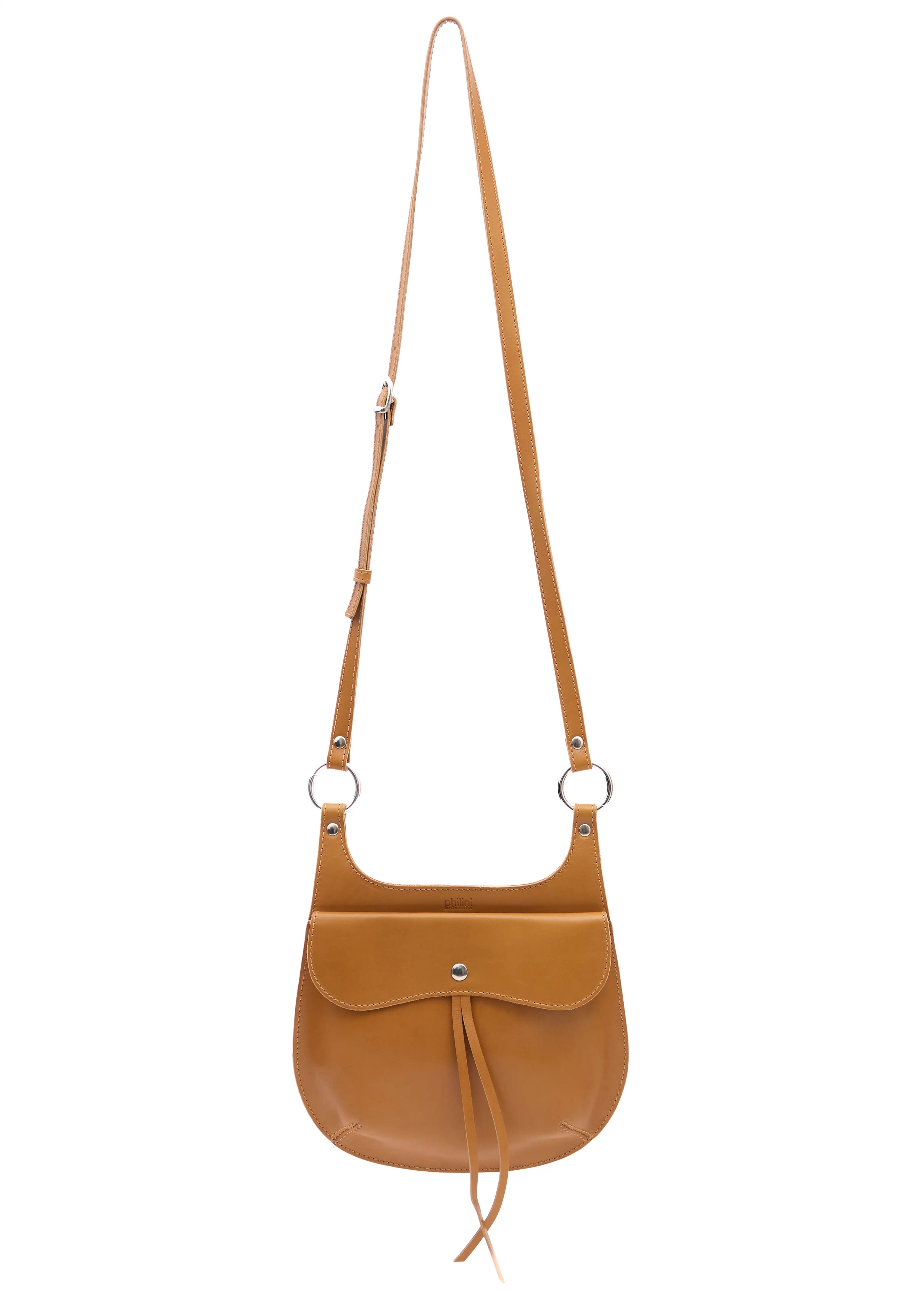 Front view of the Philini Cowboy Crossbody Bag in cognac calf leather, rounded saddle silhouette with front flap, snap closure, and long adjustable strap. Elegant handcrafted leather crossbody bag