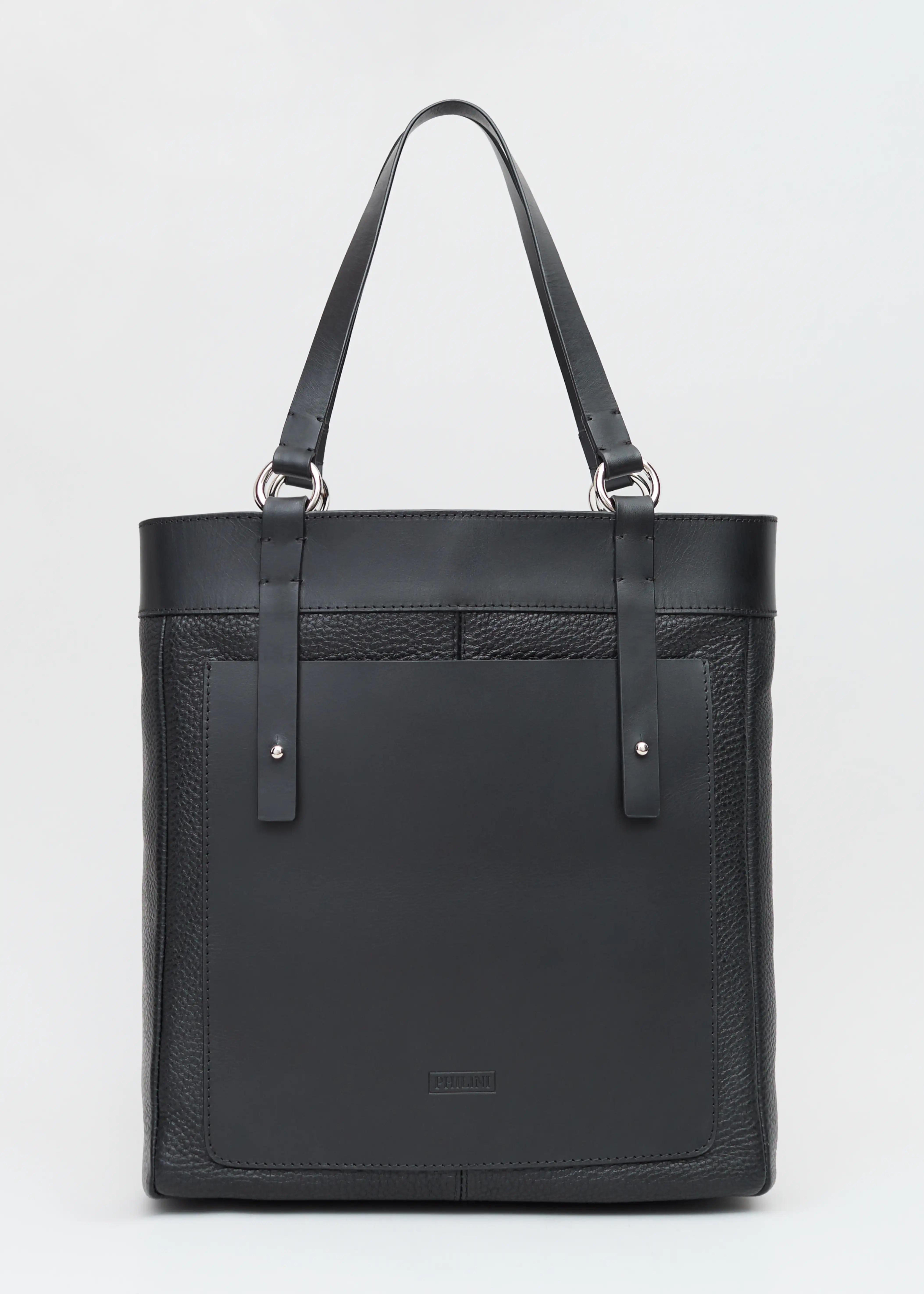 Front view of the Philini Elena Black Tote Bag crafted from two types of leather with a full-grain leather exterior pocket and silver hoops as details on the handles. This timeless and sustainable bag is perfect for modern women seeking elegance and functionality.