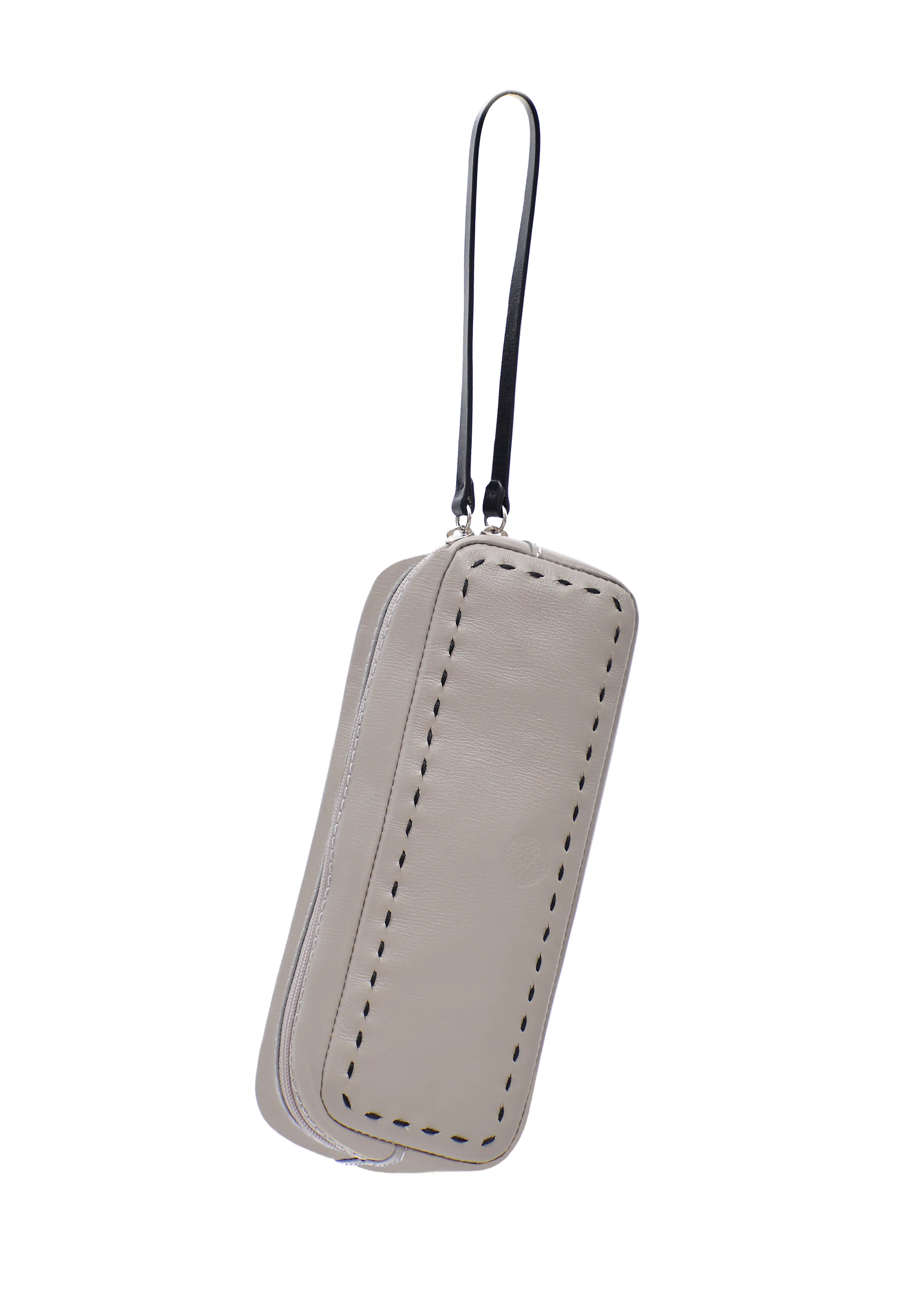 Front detail view of the Philini Ellie Cosmetic Bag in taupe aniline leather, compact rectangular shape with zip closure, leather pull, and hand-stitched finish.  Small leather bag for travel or daily makeup essentials
