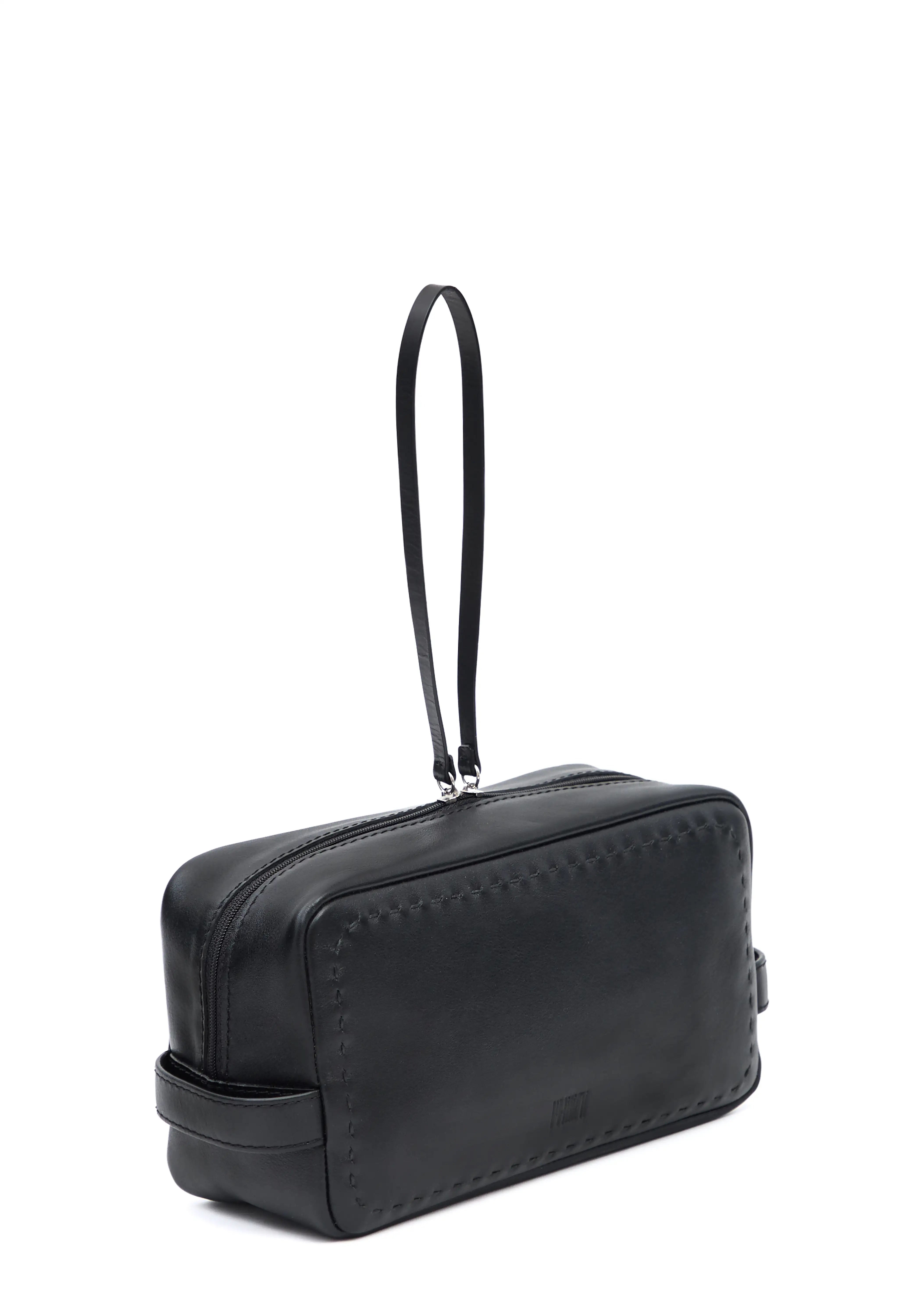 Side view of the Philini Magdalena Pouch in black leather, featuring short side handles, zip closure with leather pull, and hand-stitched edges. Sleek black cosmetic pouch, perfect as an everyday organizer or stylish accessory.