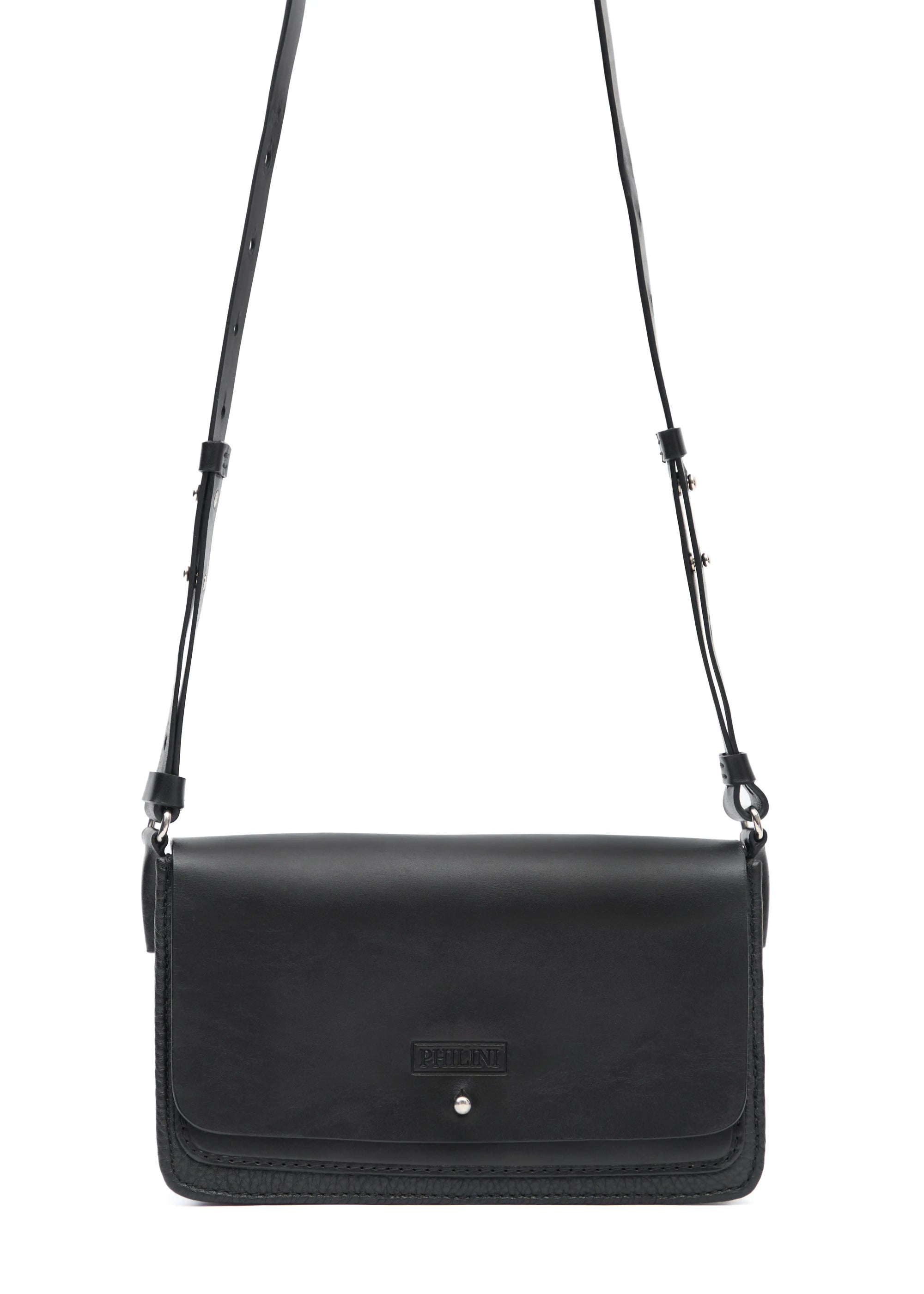 Detailed front view of the Philini Mihaela Black Wallet Bag, featuring a full-grain leather flap, buffalo leather base, silver cufflink closure, and an adjustable strap. A sustainable, handcrafted minimalist luxury handbag