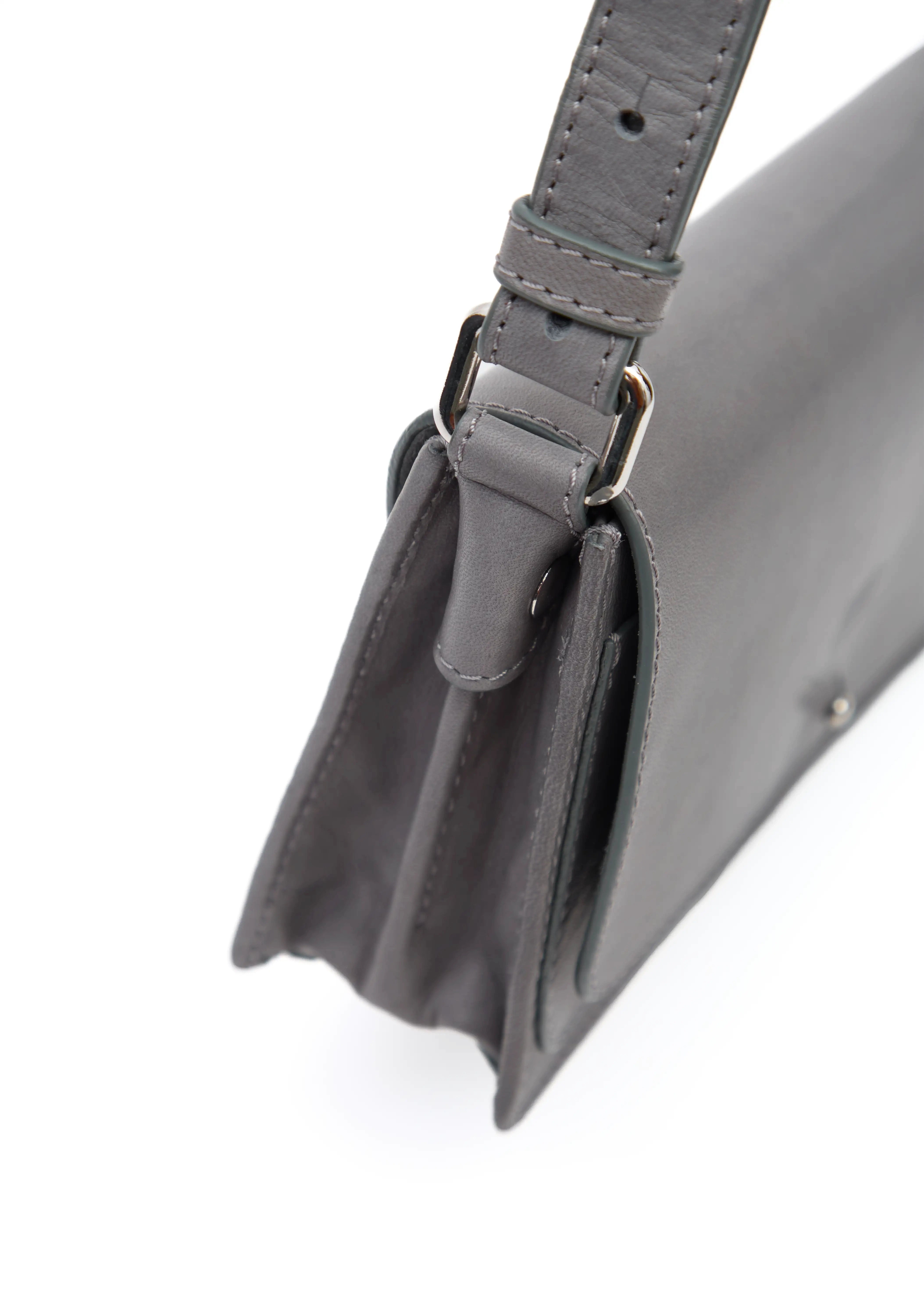 Close side view of the Philini Mihaela Wallet Bag in grey Nappa leather, highlighting the accordion sides, visible hand stitching, and silver hardware connecting the adjustable strap. This refined wallet crossbody blends compact luxury with functional minimalist style
