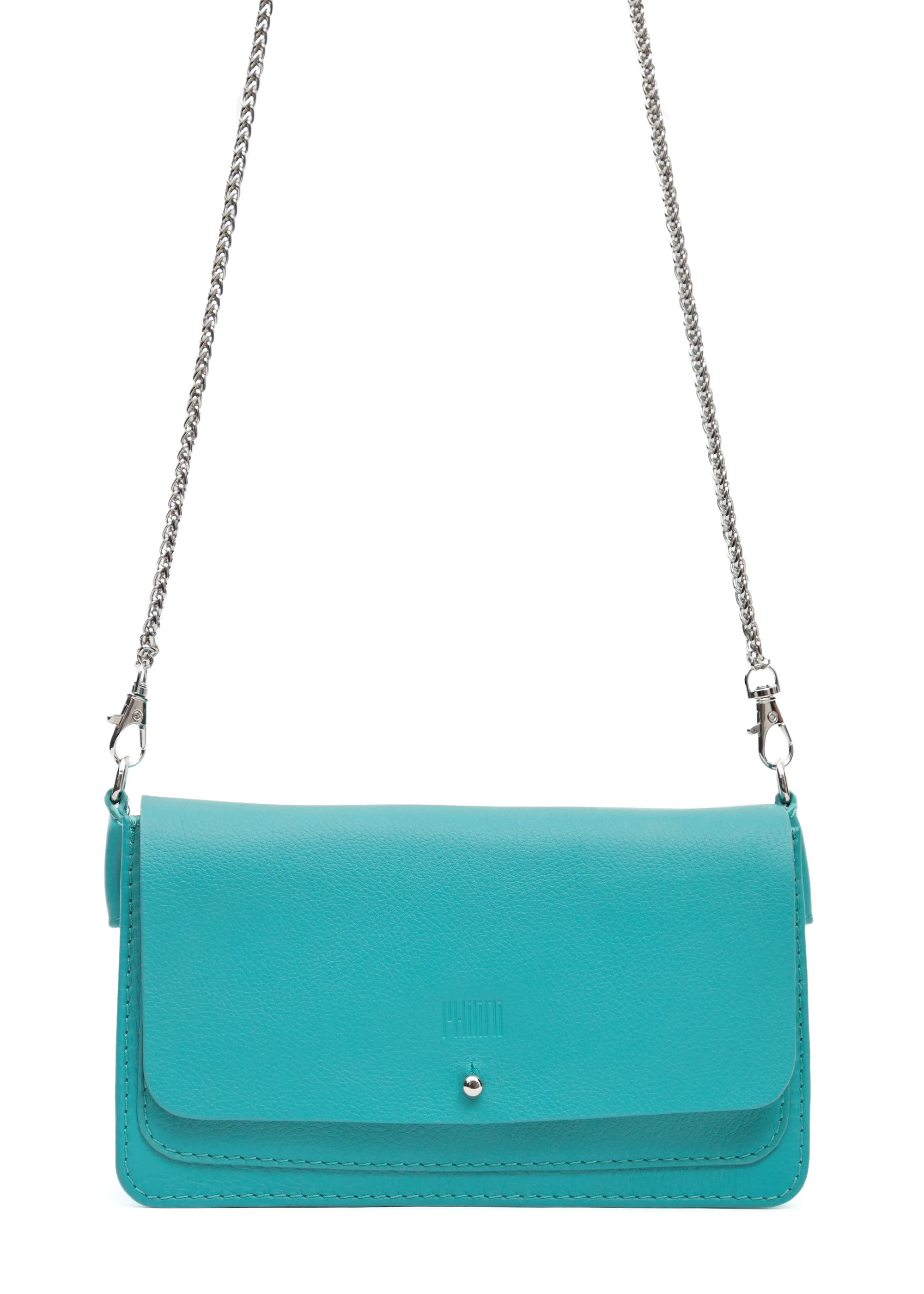 Close-up front view of the Philini Mihaela Wallet Bag in turquoise nappa leather, showing the rectangular shape, front flap with silver cufflink closure, stamped logo, and silver chain handle with carabiners. A compact, handcrafted designer wallet bag for conscious luxury and slow fashion.