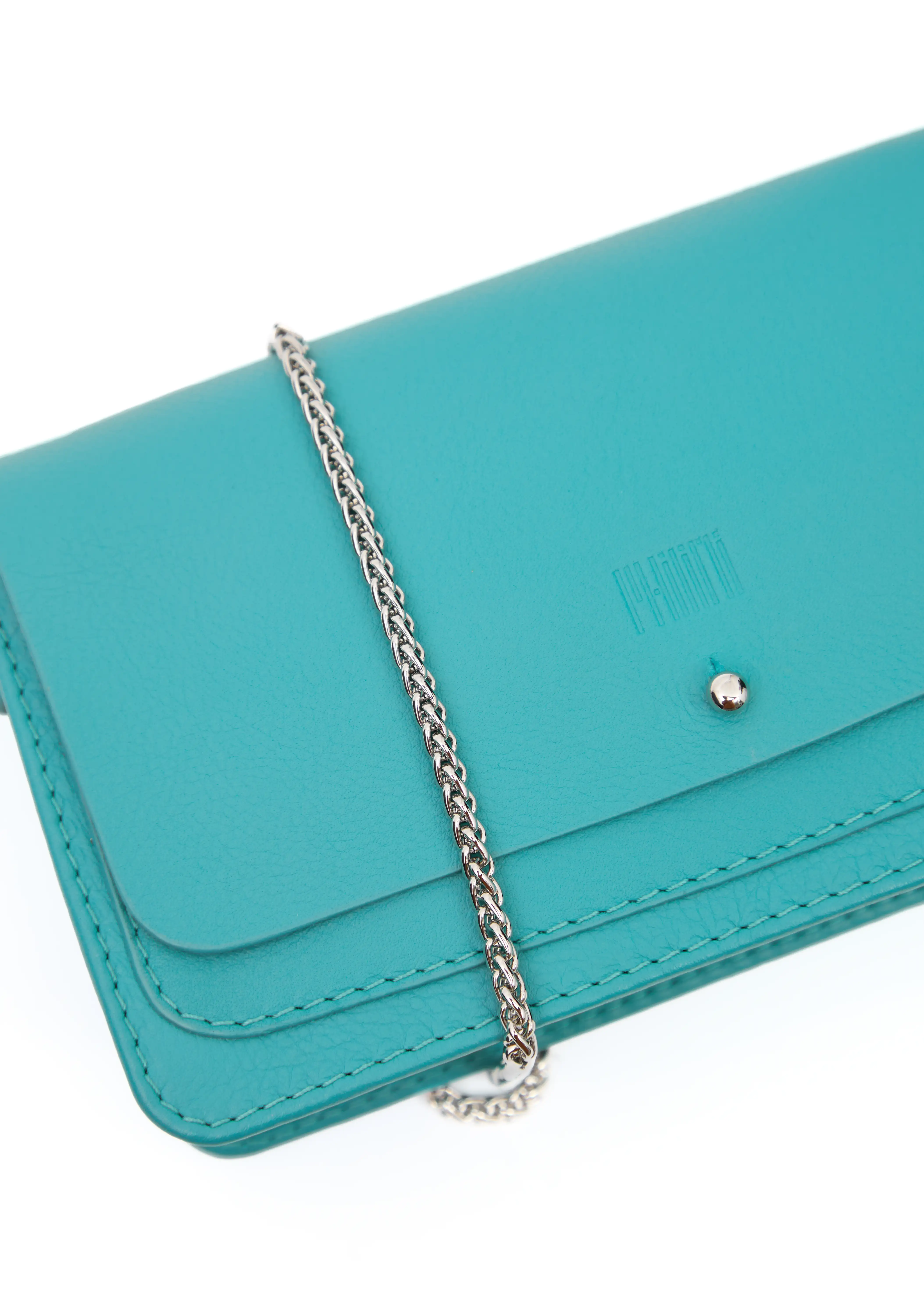 Close front view of the Philini Mihaela Wallet Bag in turquoise nappa leather, showing the rectangular shape, front flap with silver cufflink closure, stamped logo, handcrafted stitching, and detailed metal chain handle. The designer ladies wallet