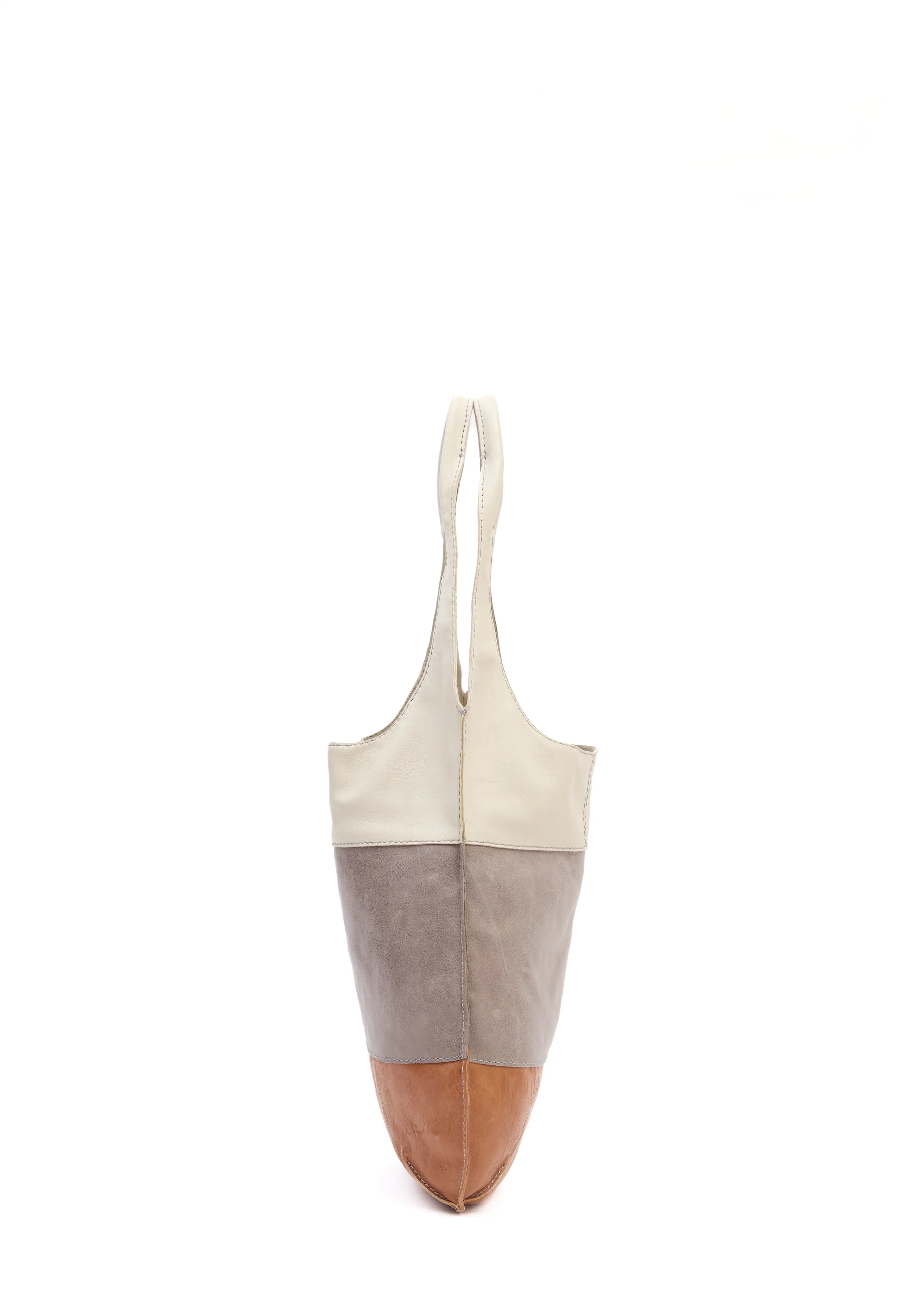 Side view of the Philini Semfira Hobo Bag in cognac wild calf leather, featuring three gentle-tone straps with integrated handles and hand-stitched detailing. Ethical handcrafted leather hobo