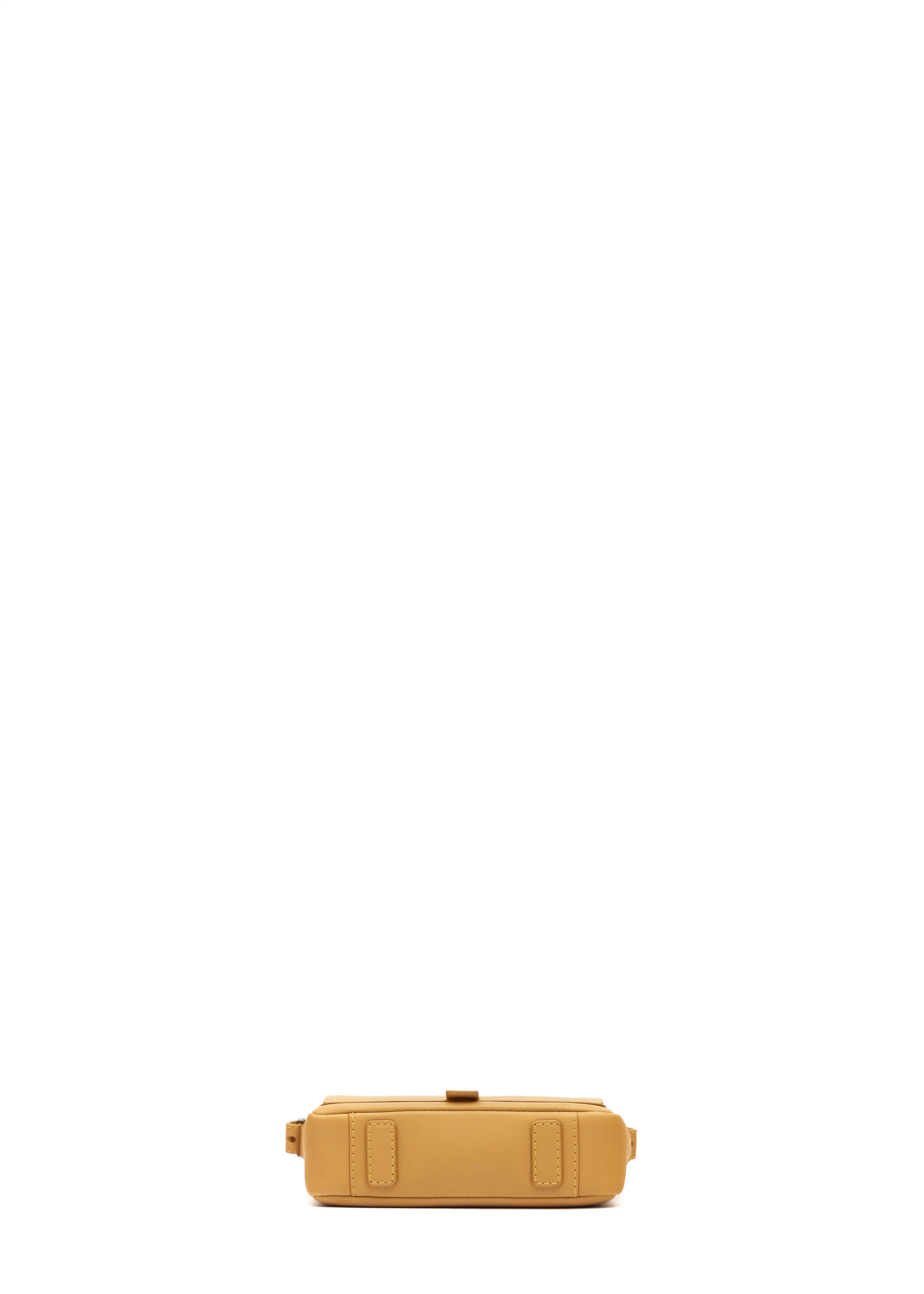 Bottom view of the Philini Whitney Mini Crossbody Bag in yellow nappa leather, featuring two leather pads as protective feet. The crossbody bag is a handcrafted mini purse