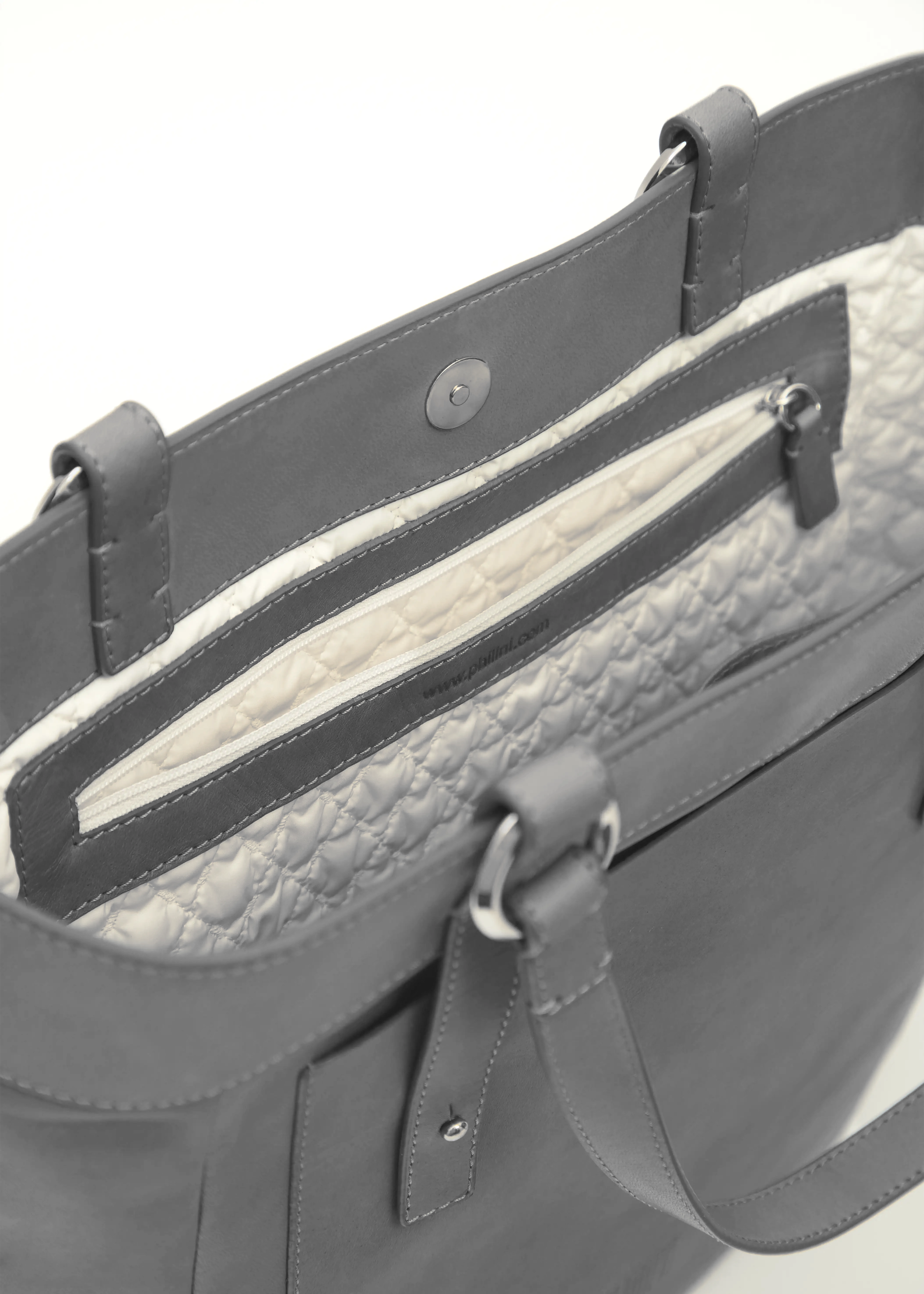 Interior view of the Philini Elena Grey Tote Bag, featuring a magnetic closure, deep zippered pocket, and detailed stitching along all edges. A subtle stamp links directly to website