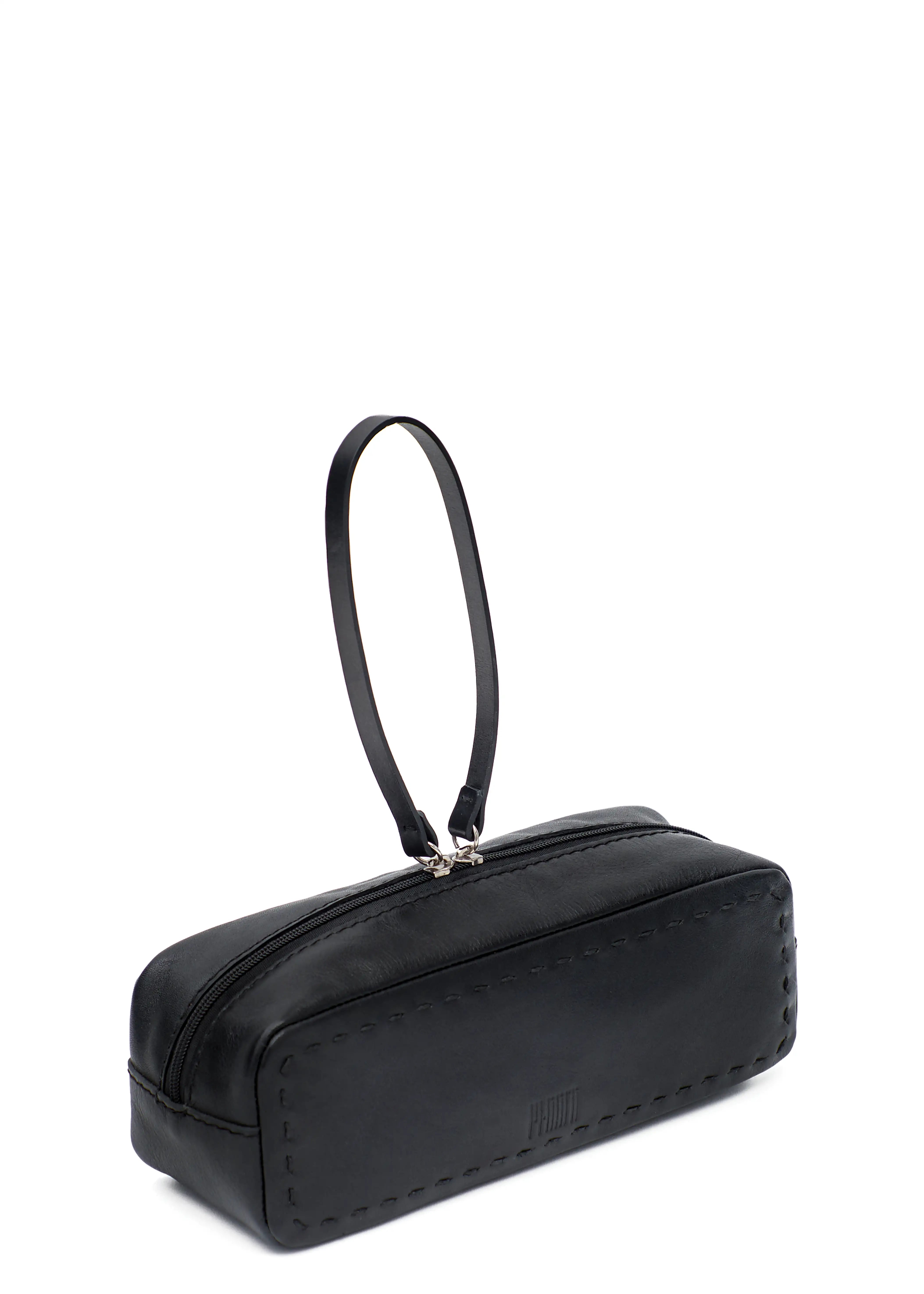 Side view of the Philini Ellie Cosmetic Bag in black aniline leather, highlighting the hand-stitched finish, zip closure with leather pull, and front-stamped Philini logo. Elegant leather compact travel case.