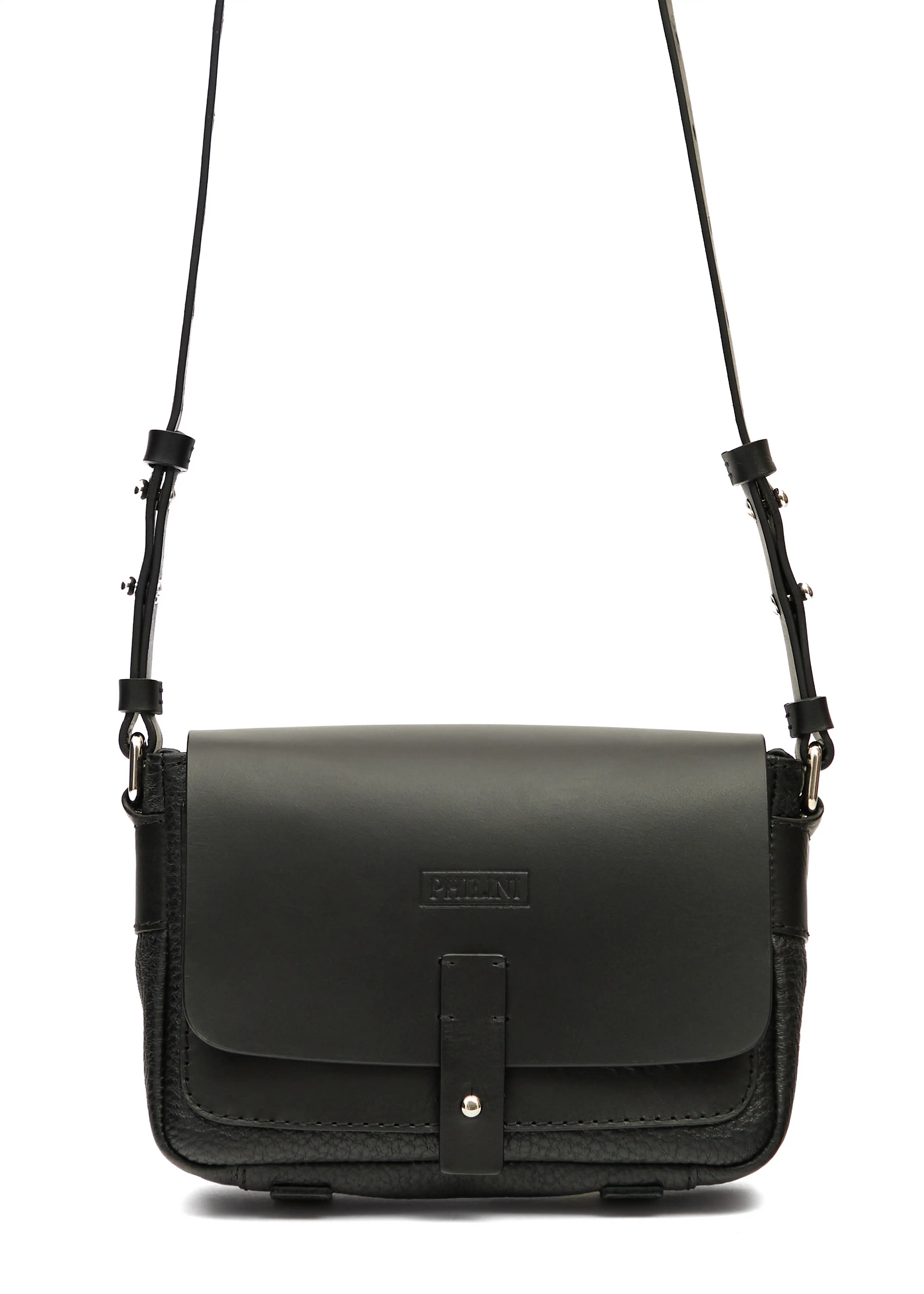 Close-up front view of the Philini Whitney Black Leather Bag, a rectangular handcrafted designer bag with a premium leather flap, silver push-button closure, adjustable strap, and protective leather pads. A sustainable and elegant accessory