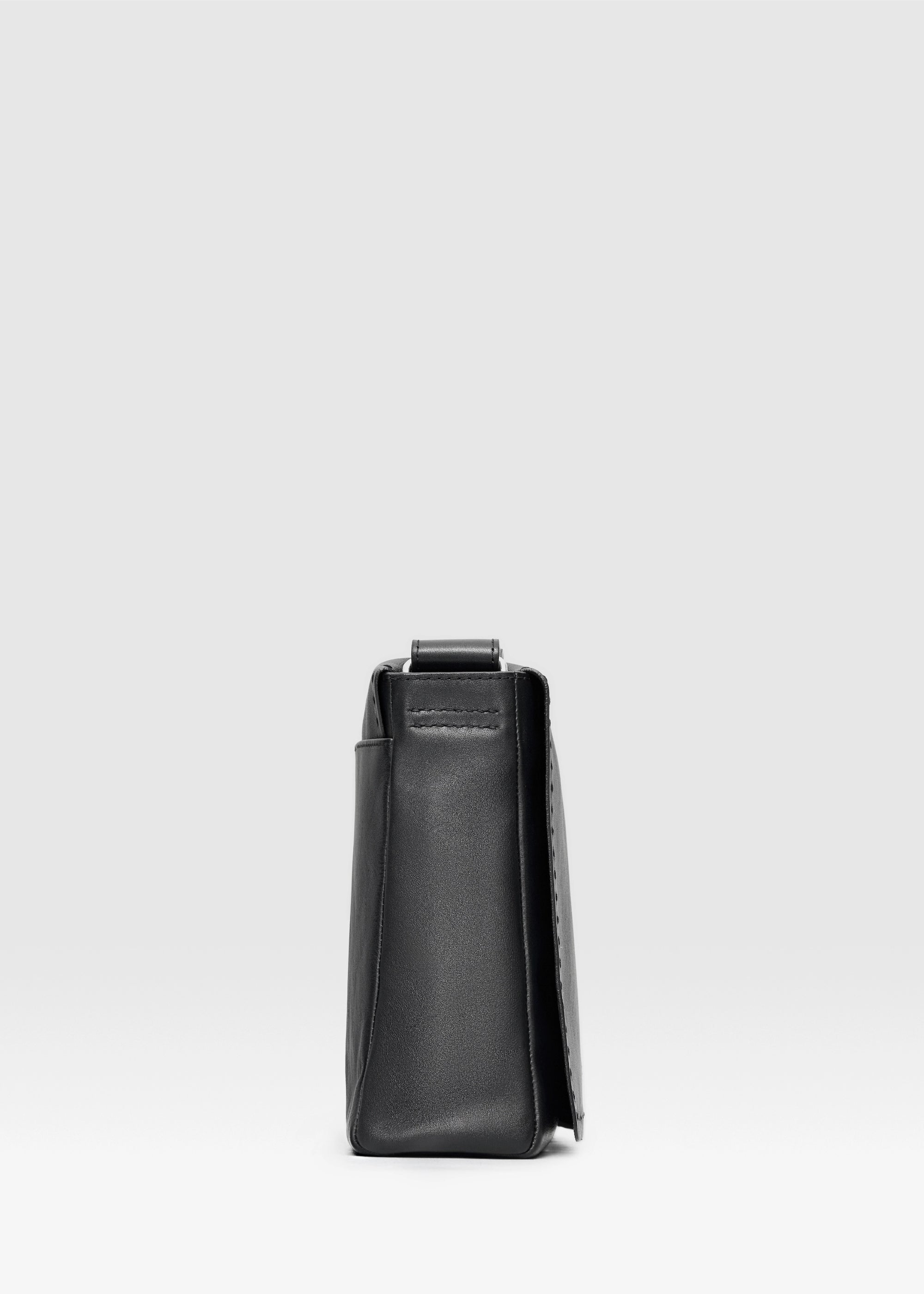 Profile view of the Philini Anastasia Messenger Bag in black aniline nappa leather, featuring a structured square design, full front flap, and hand-stitches. Stylish black leather shoulder bag for everyday wear