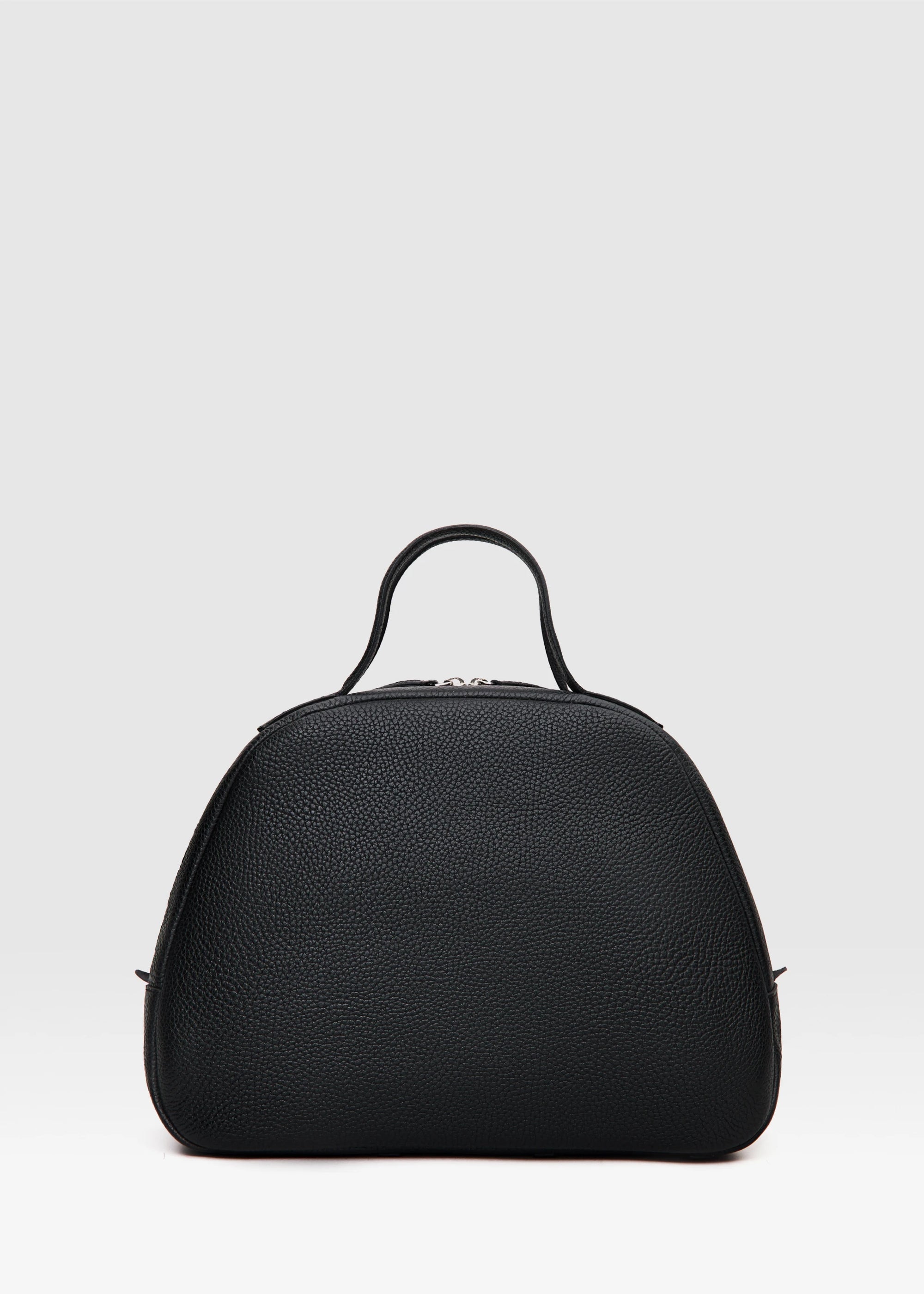 Back view of the Philini Domi Black Dome Handbag, crafted from premium buffalo leather with short handles, silver rivets, and a sleek zipper. This eco-conscious leather bag is a sustainable designer accessory.