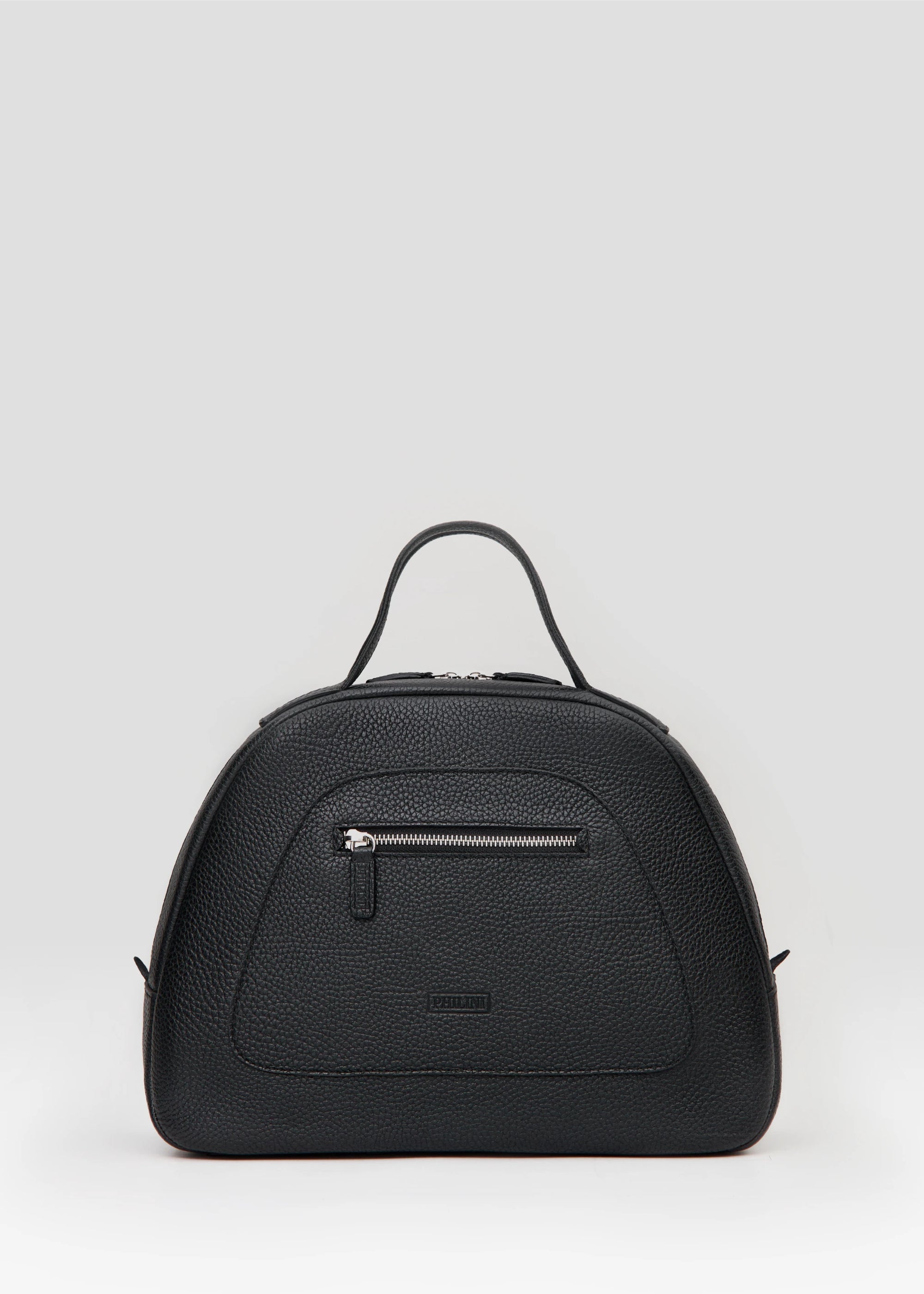 Front view of the Philini Domi Black Handbag, dome-shaped and crafted from buffalo leather with a small front zip pocket, short handles, and silver rivets. A luxury, handcrafted leather bag.