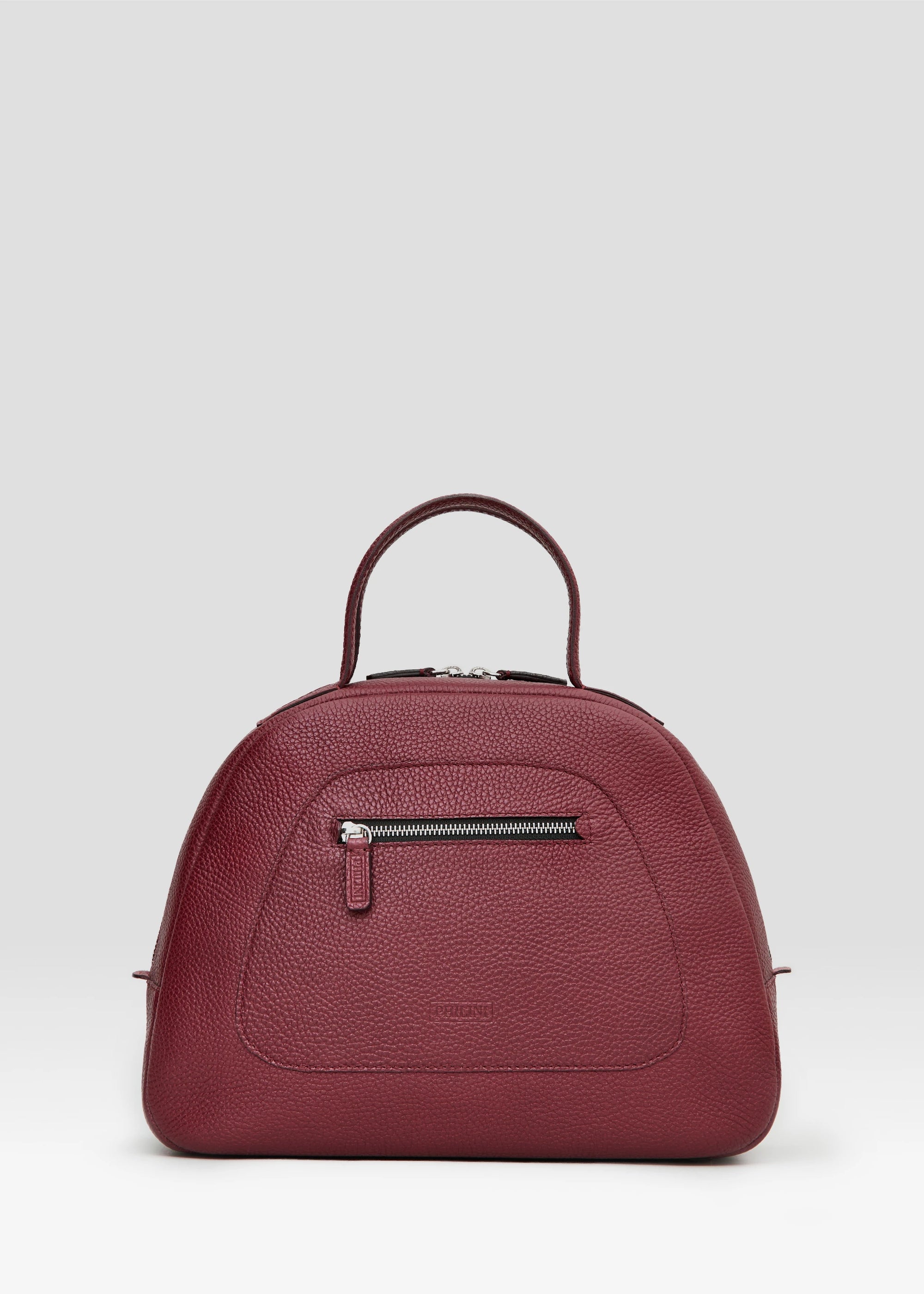Front view of the Philini Domi Red Handbag in calf leather with short handles, silver rivets, and front zip pocket
