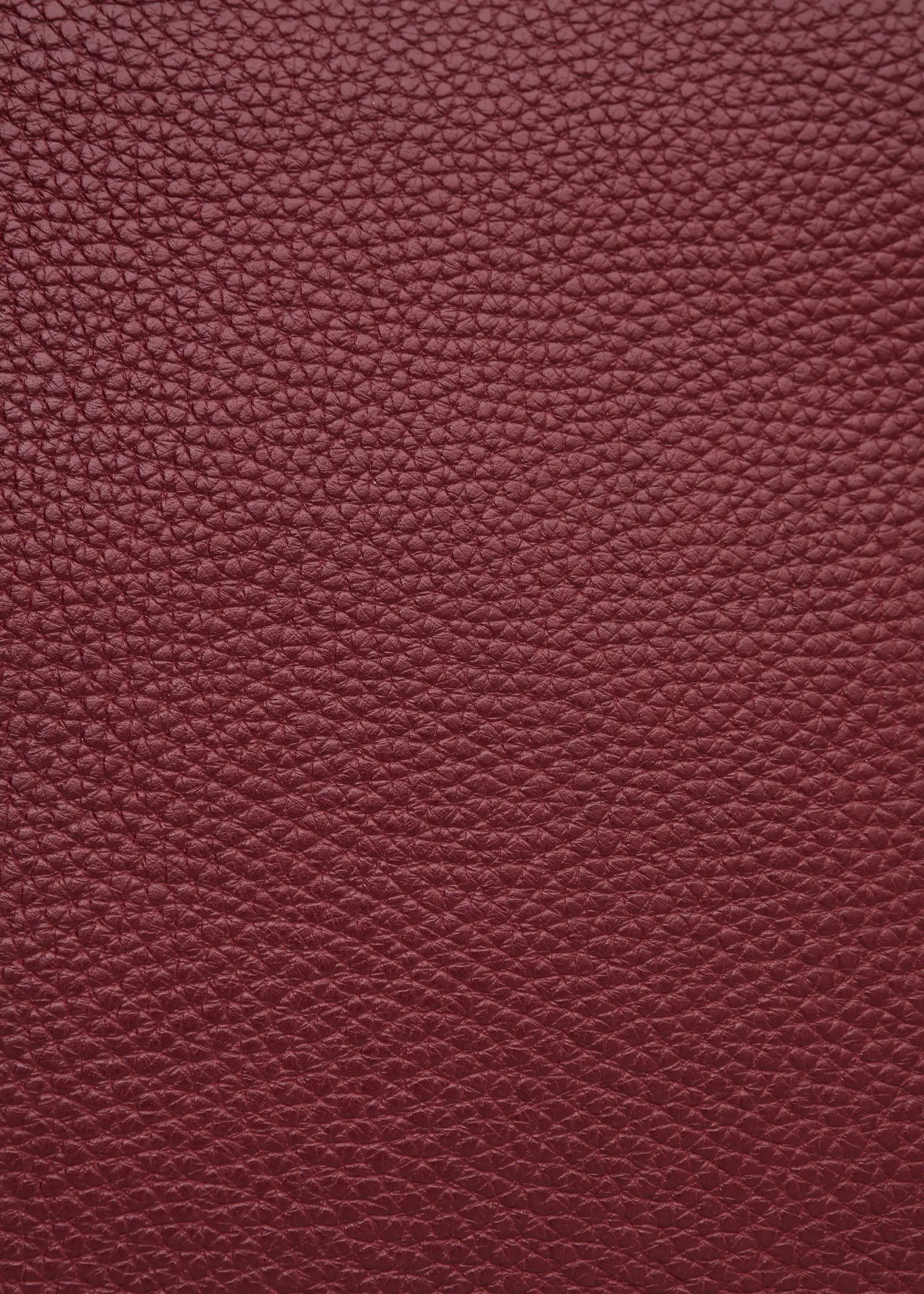 Texture view of the Philini Domi red Handbag in dome shape, handcrafted from calf leather.