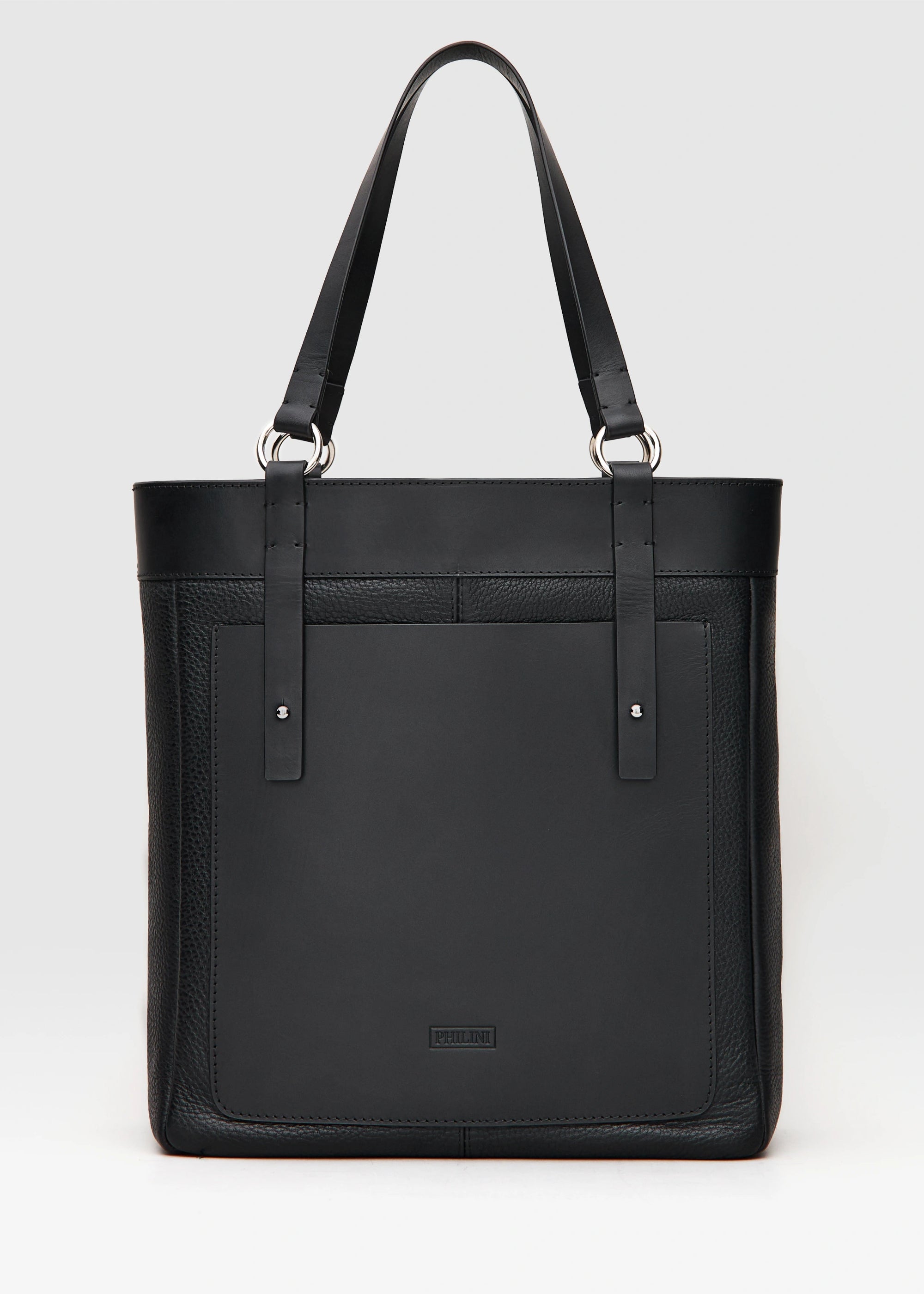 Front view of the Philini Elena Black Tote Bag crafted from two types of leather with a full-grain leather exterior pocket and silver hoops as details on the handles. This timeless and sustainable bag is perfect for modern women seeking elegance and functionality. 