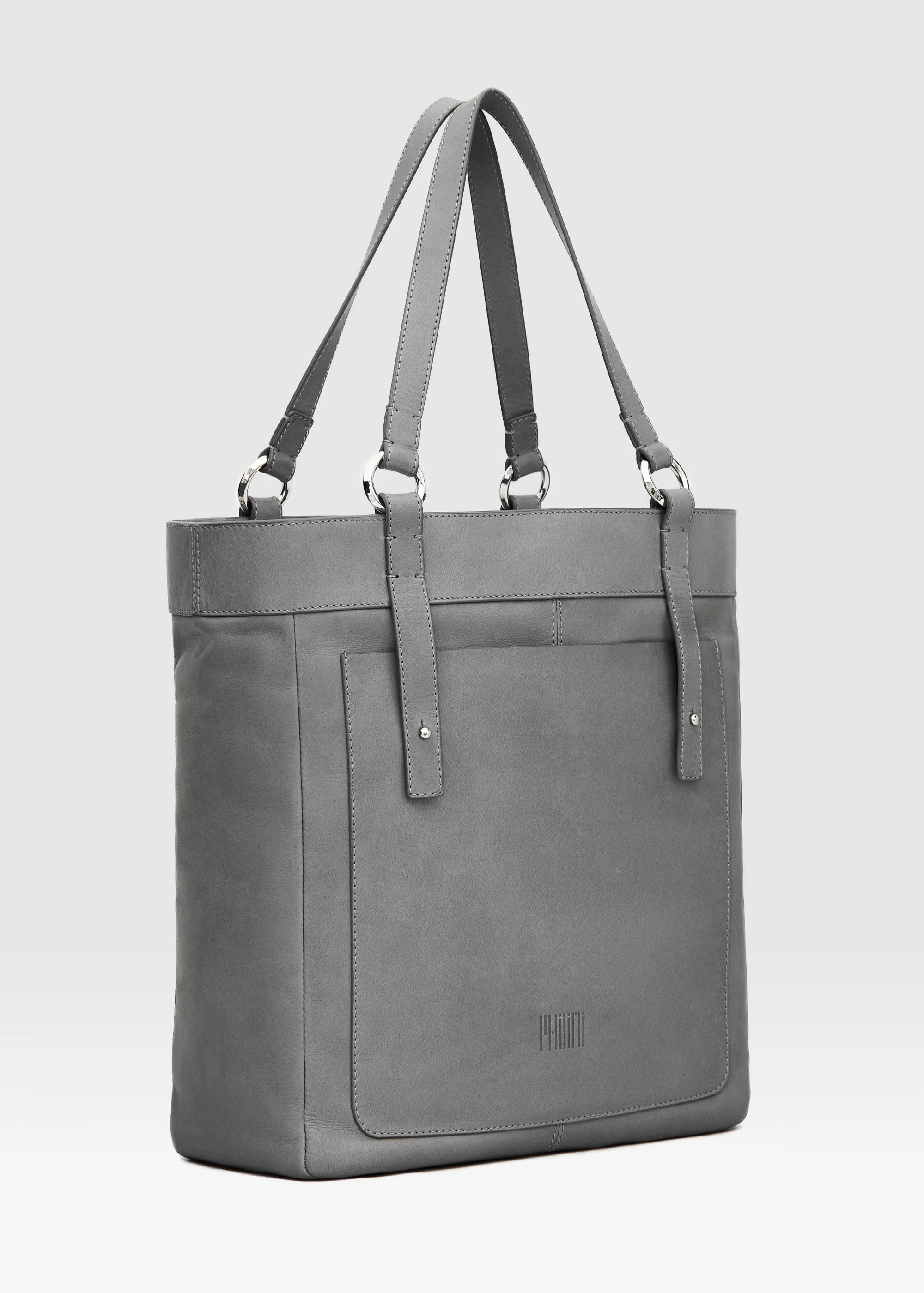 Side view of the Philini Elena Grey Tote Bag in smooth grey aniline leather, featuring a leather exterior pocket, hand-stitched handles with silver hoop accents. A elevated designer essential.