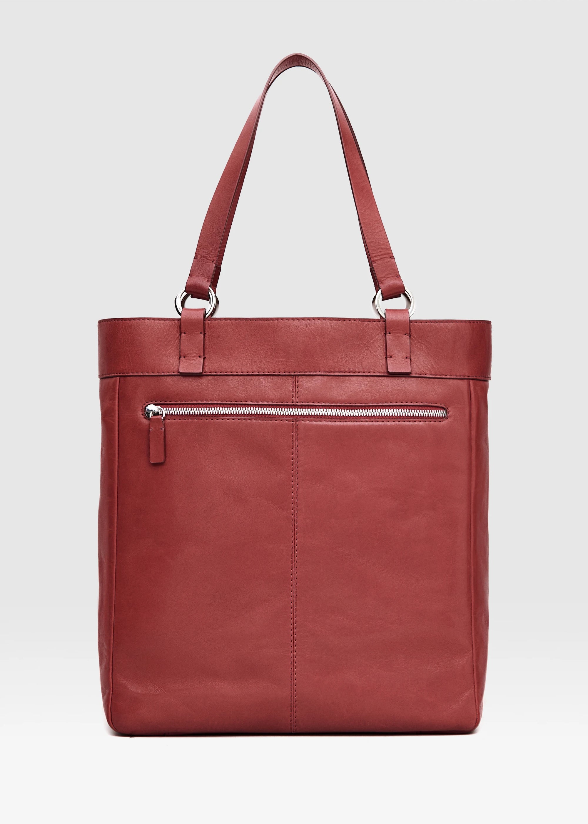Back view of the Philini Elena Red Tote Bag in red aniline leather, highlighting its tote silhouette, zippered back compartment, and handles with silver hoop accents. This sustainable, handcrafted luxury leather handbag is a timeless accessory.