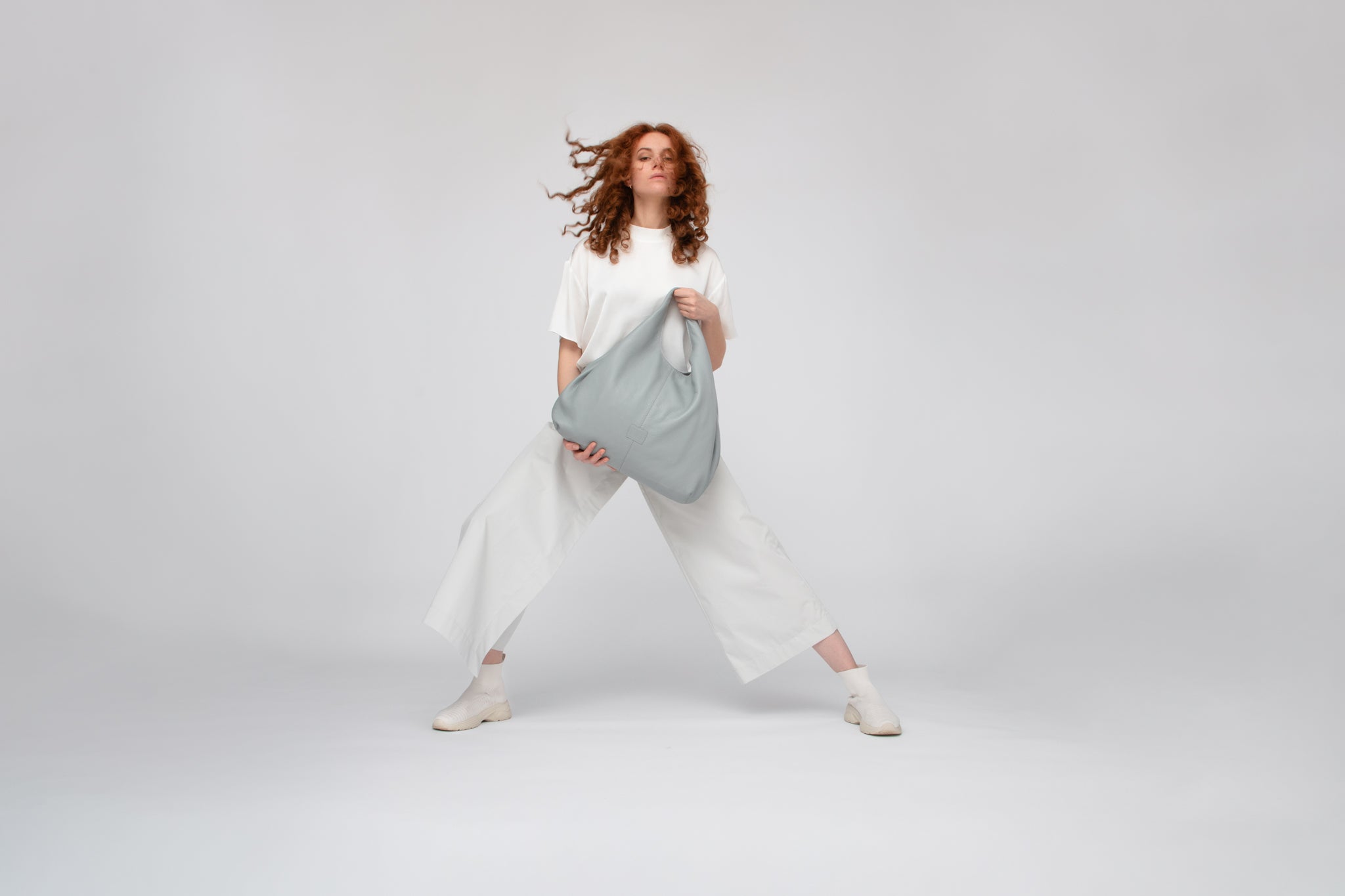 White outfit with grey leather hobo bag by Philini