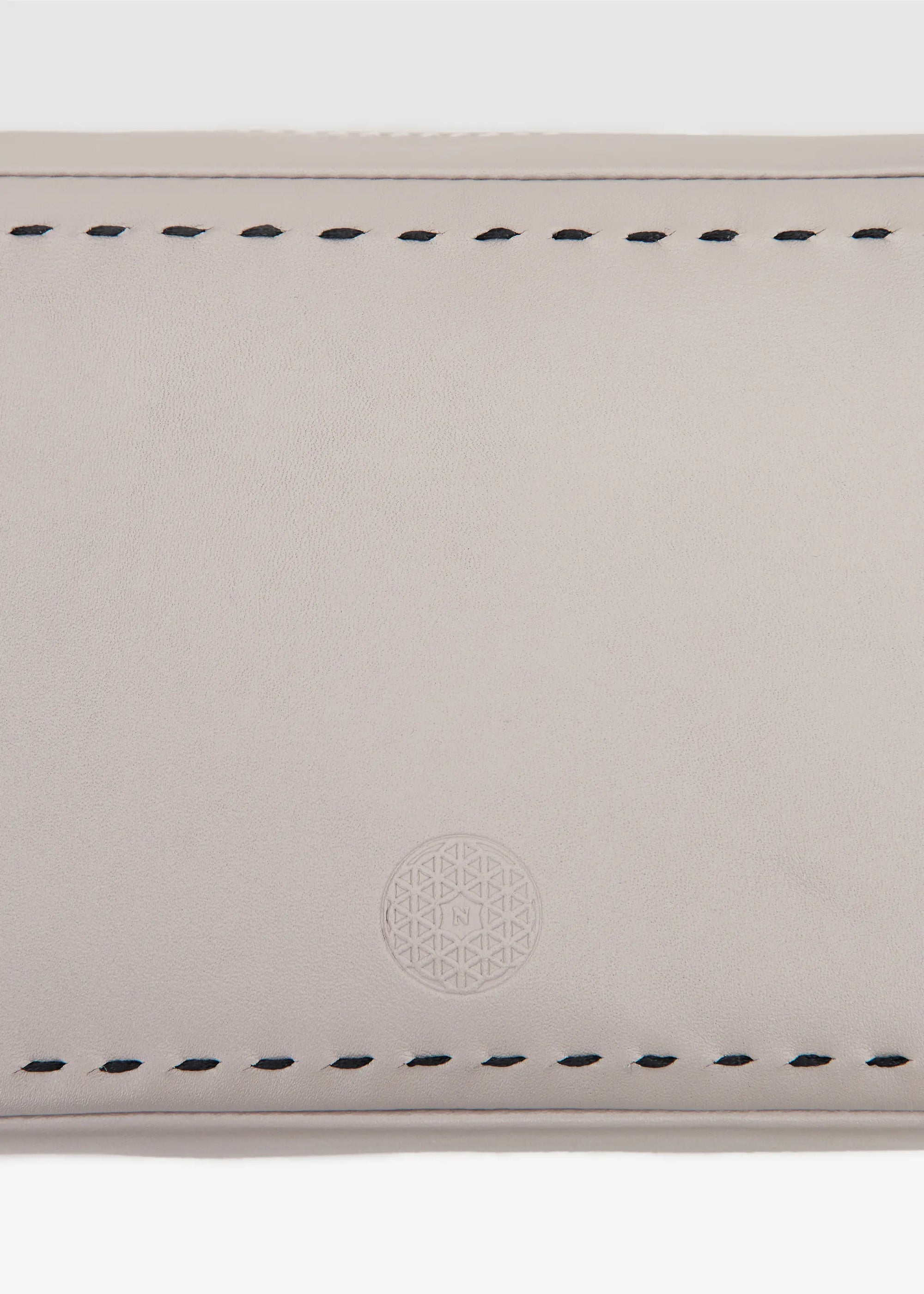 Close front view of the Philini Magdalena Pouch in taupe leather, rectangular shape with two short handles, zip closure with leather pull, hand-stitched sides, and stamped logo. Minimalist small leather pouch for travelling 