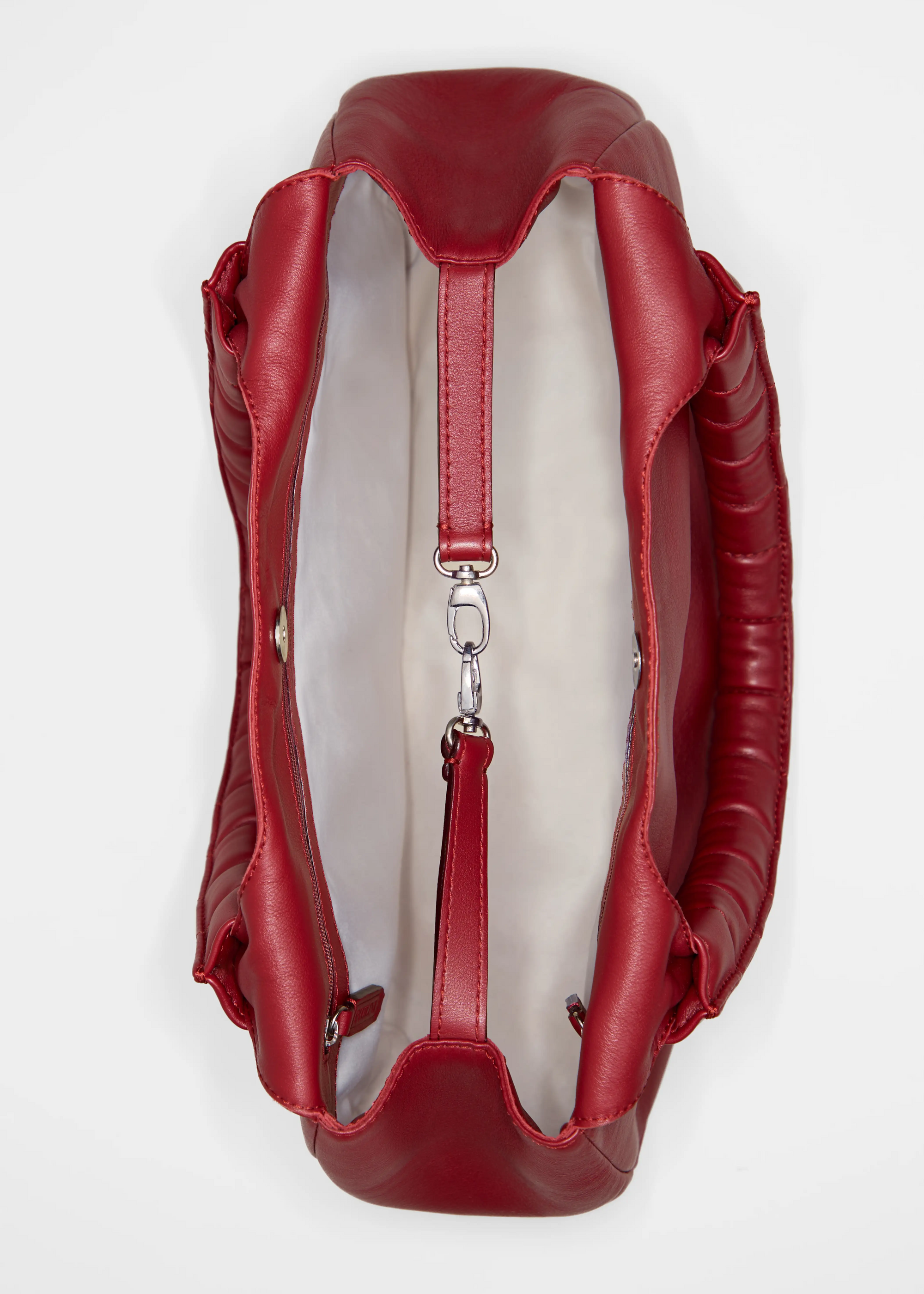 Inside view of the Philini Adreann Hobo Bag in red nappa leather, showing soft vanilla lining, dual spacious zip pockets, and leather shaping plates with silver accents. Premium handcrafted leather bag