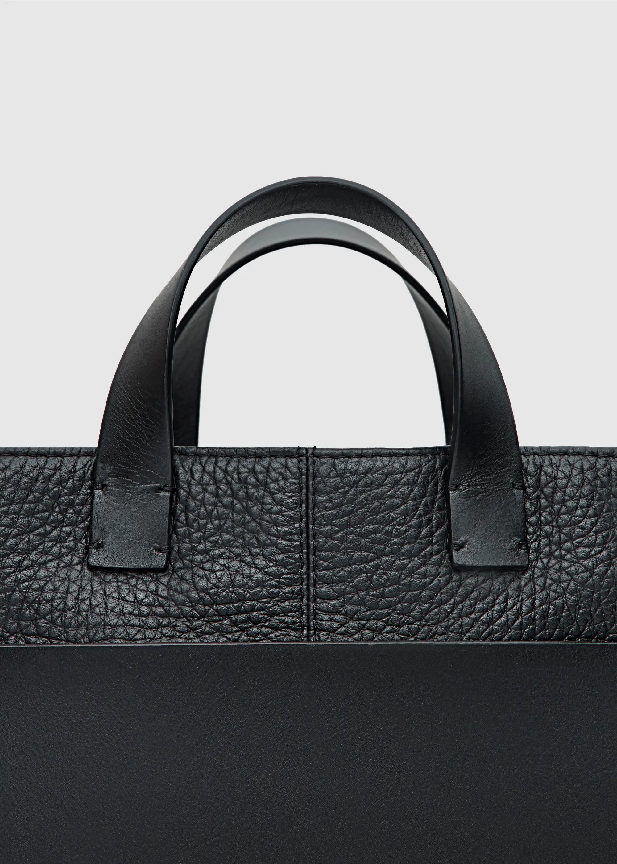 Close-up of the Philini Andrea Bag in Black – Showcasing the embossed Philini logo and the luxurious combination of buffalo and full-grain. This handcrafted tote bag highlights premium materials, timeless design, and exceptional craftsmanship.