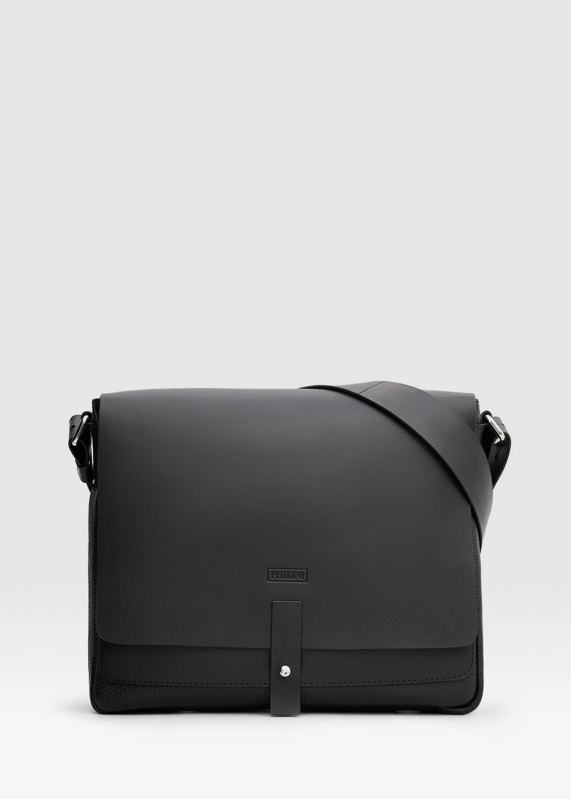 Philini Aneta Bag in black, a luxurious handcrafted leather messenger bag designed for women who value timeless elegance, sustainability, and individuality. Featuring a sleek rectangular design with top handles and a detachable shoulder strap, this versatile bag is perfect for professional and casual occasions.