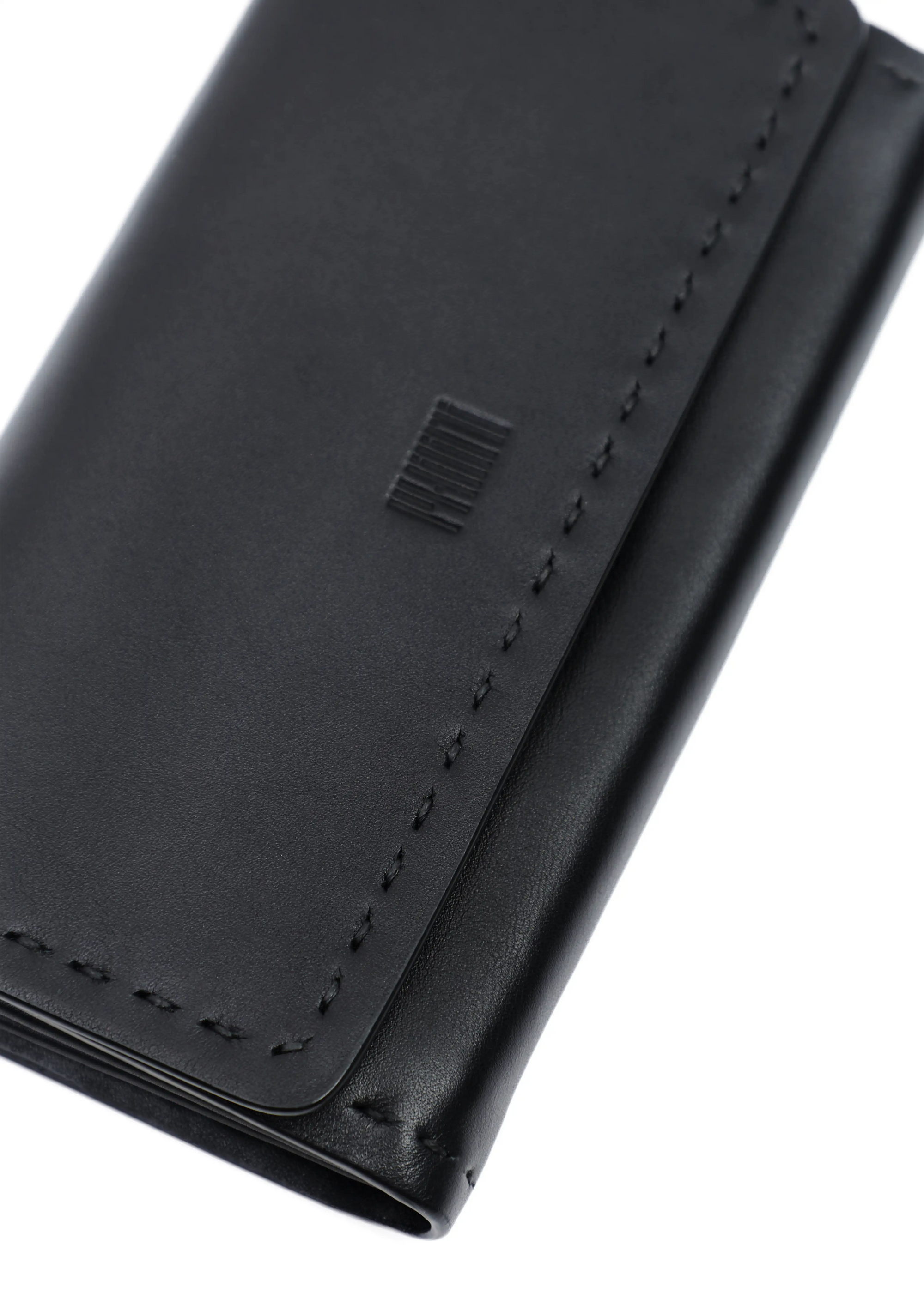Close-up front view of the Philini Birgit Wallet in black nappa leather, rectangular shape with stamped logo on front flap and hand-stitched sides. Chic modern women’s wallet, slim and stylish for everyday essentials.