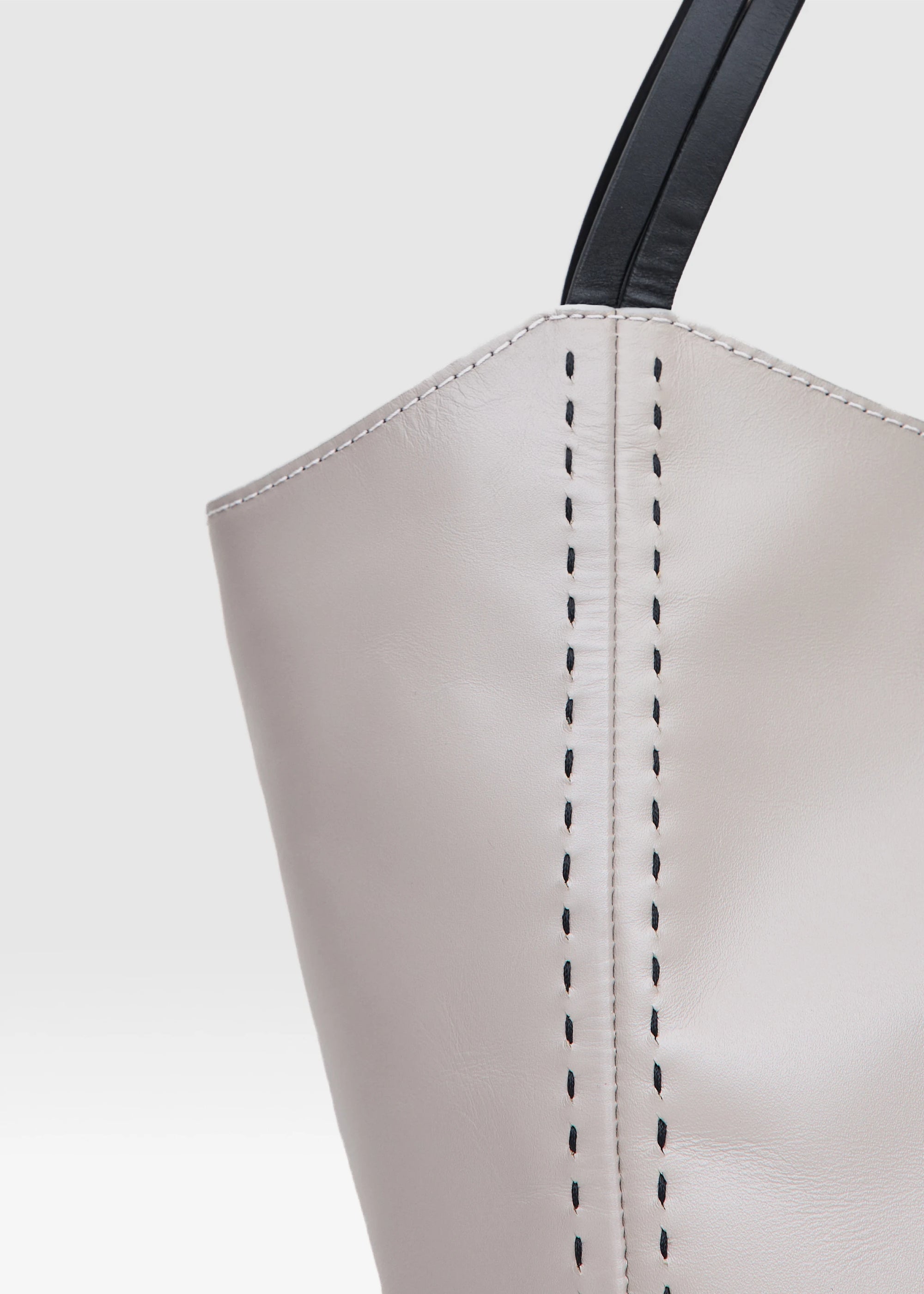 Close front view of the Philini Charlotte Tote Bag in taupe aniline calf leather, showing double flat handles and black hand-stitching. Luxury leather tote, elegant and spacious for everyday use.