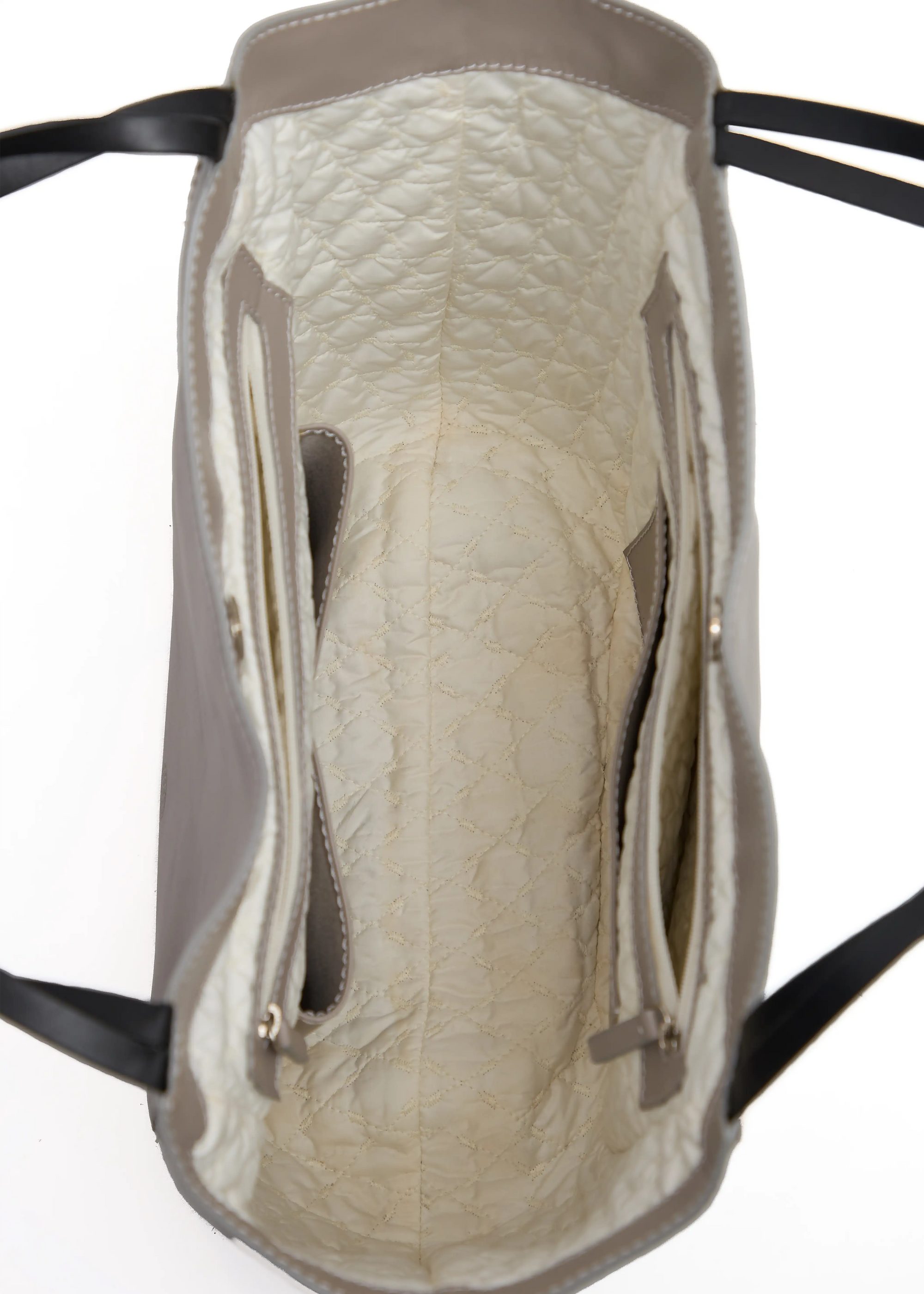 Inside view of the Philini Charlotte Tote Bag in taupe aniline calf leather, showing stitched vanilla lining, open and zip pockets with leather trim, and divided compartments. Spacious luxury leather tote with magnetic closure, ideal for everyday organization