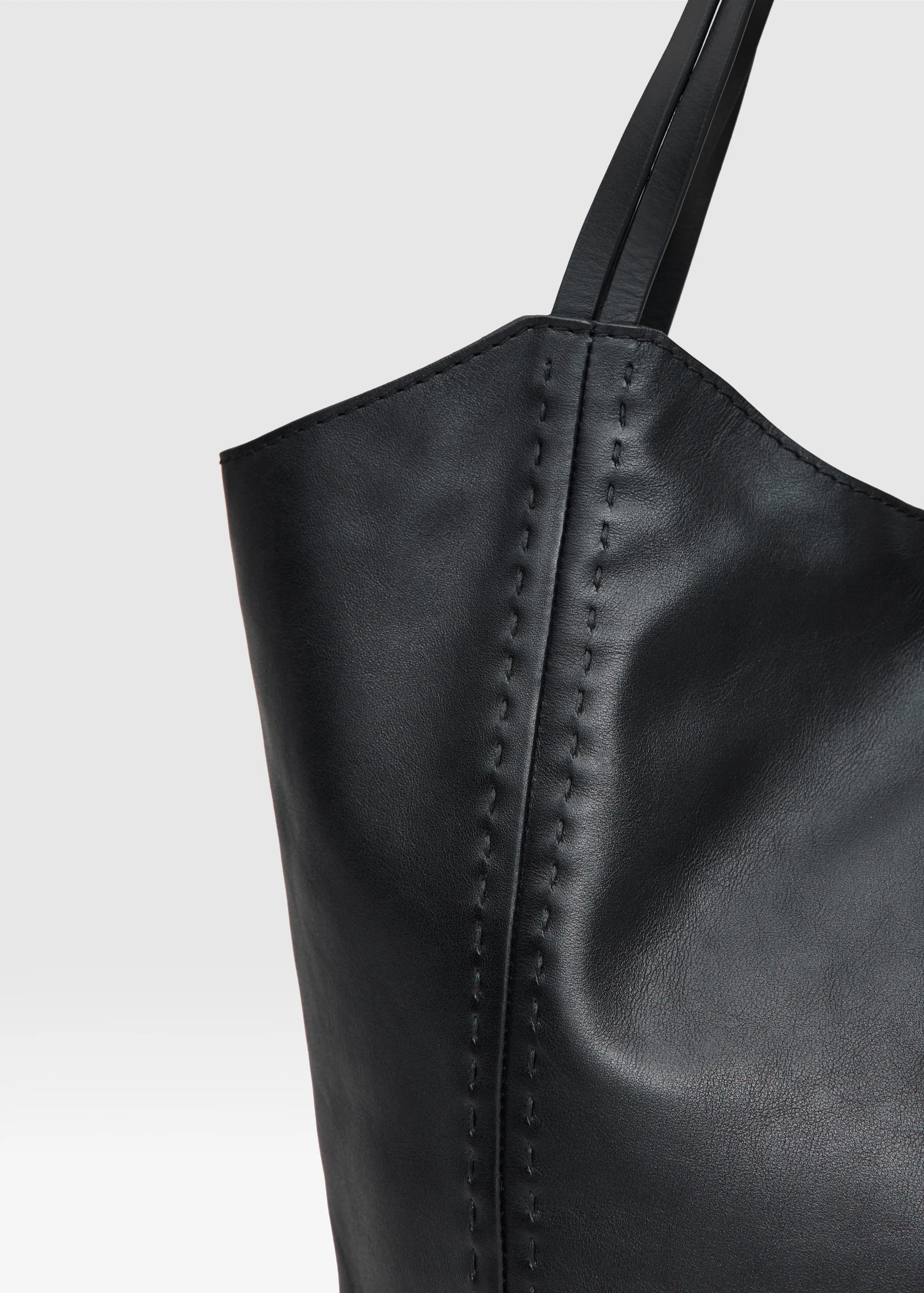 Close Up of Black leather handbag  Charlotte from Philini bags on a light gray background