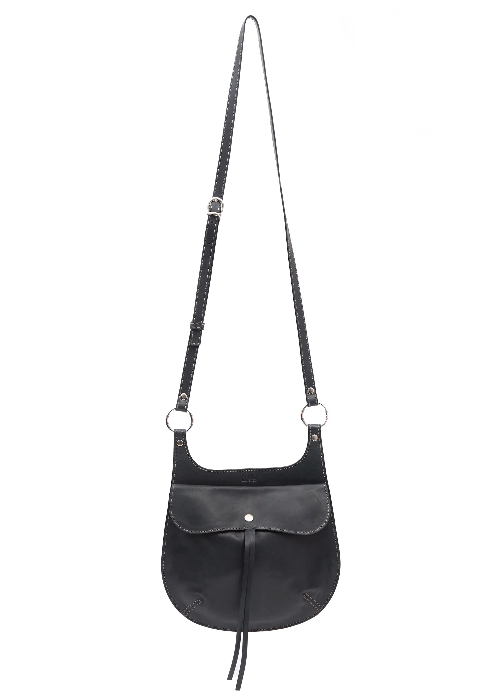 Front view of the Philini Cowboy Black Crossbody Saddle Bag in calf leather with rounded silhouette, snap closure, and adjustable strap
