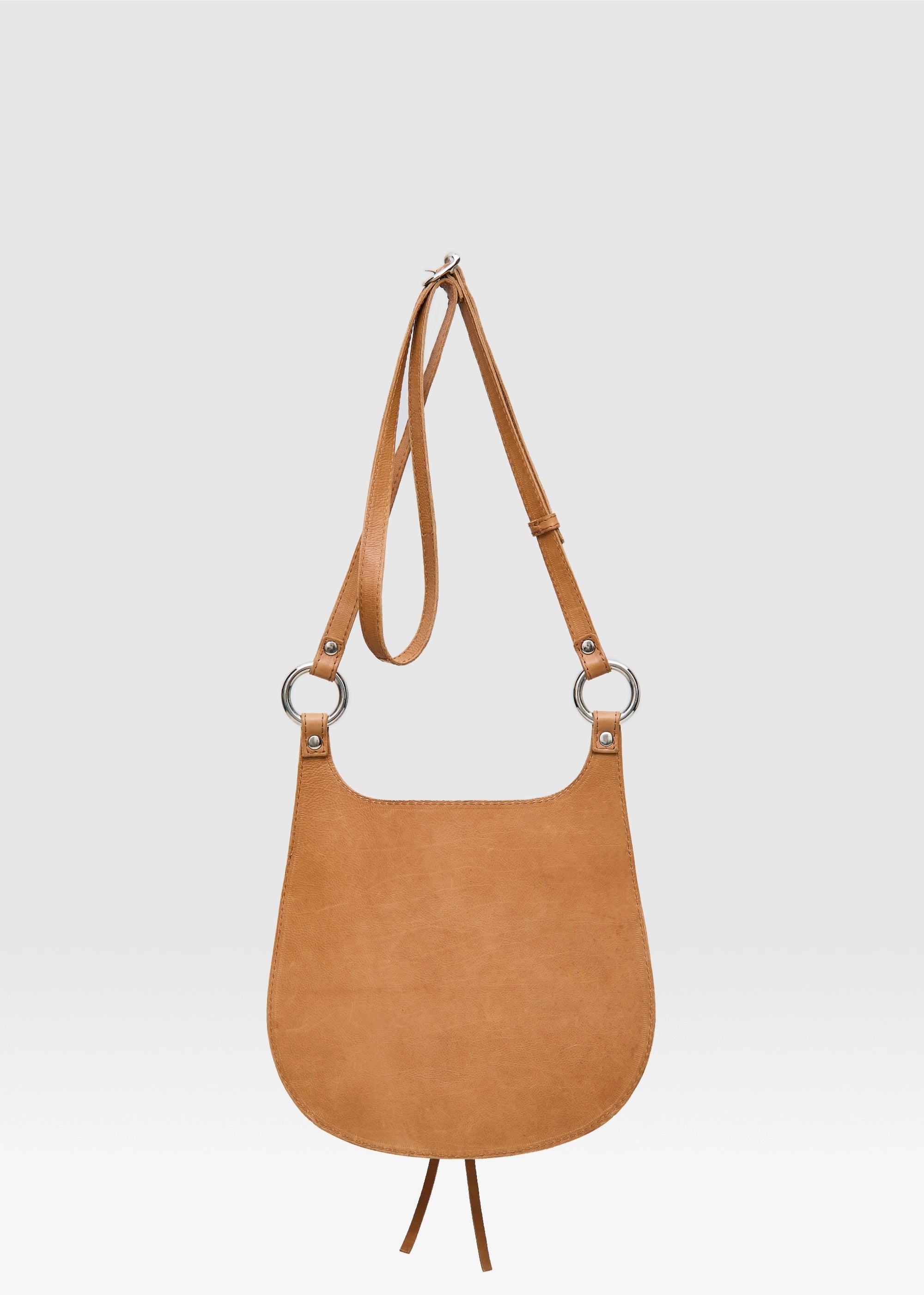Back view of the Philini Cowboy Crossbody Bag in cognac calf leather, smooth curved silhouette 