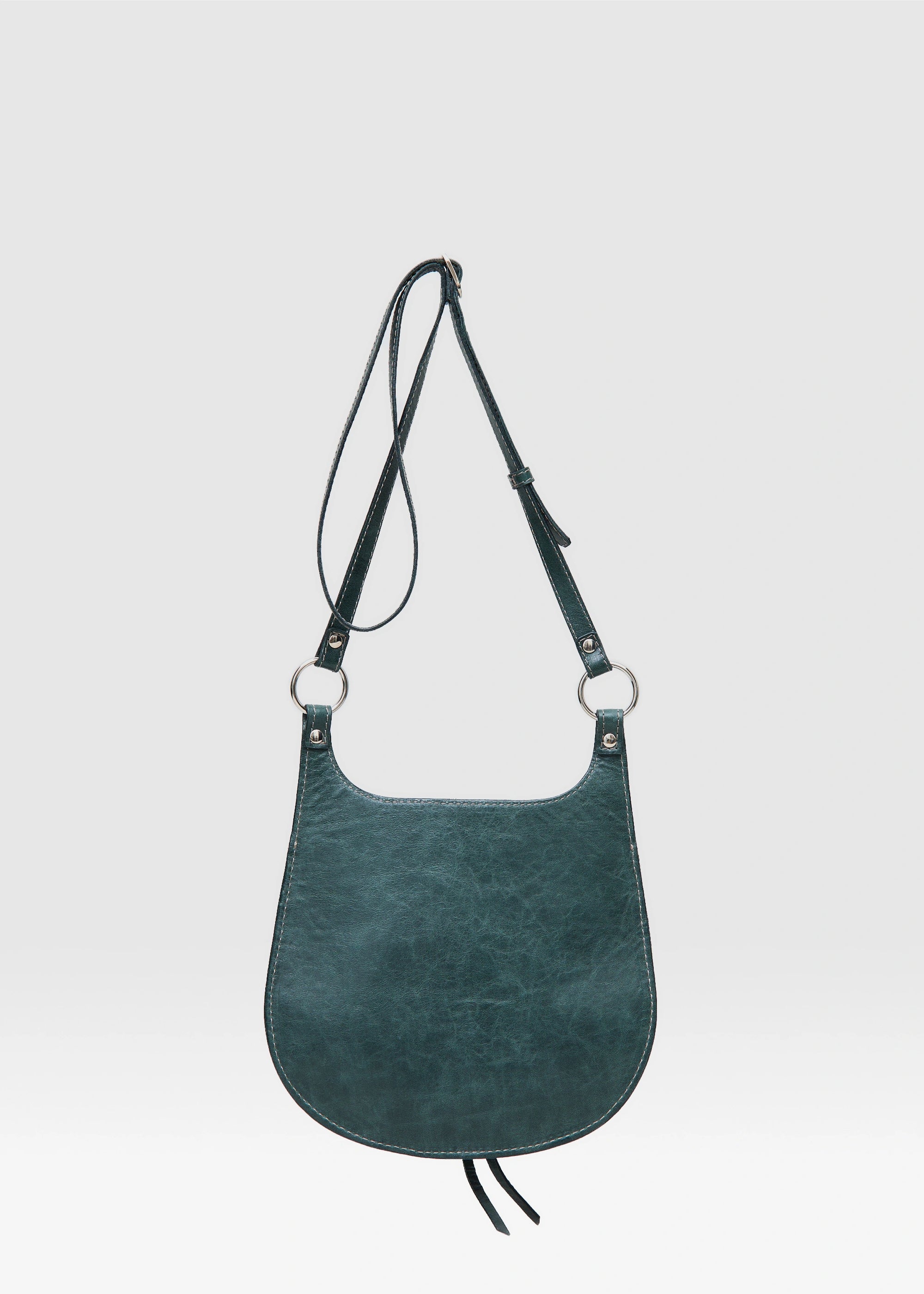 Back view of the Philini Cowboy Crossbody Bag in dark green calf leather, smooth rounded silhouette with flat back and adjustable strap