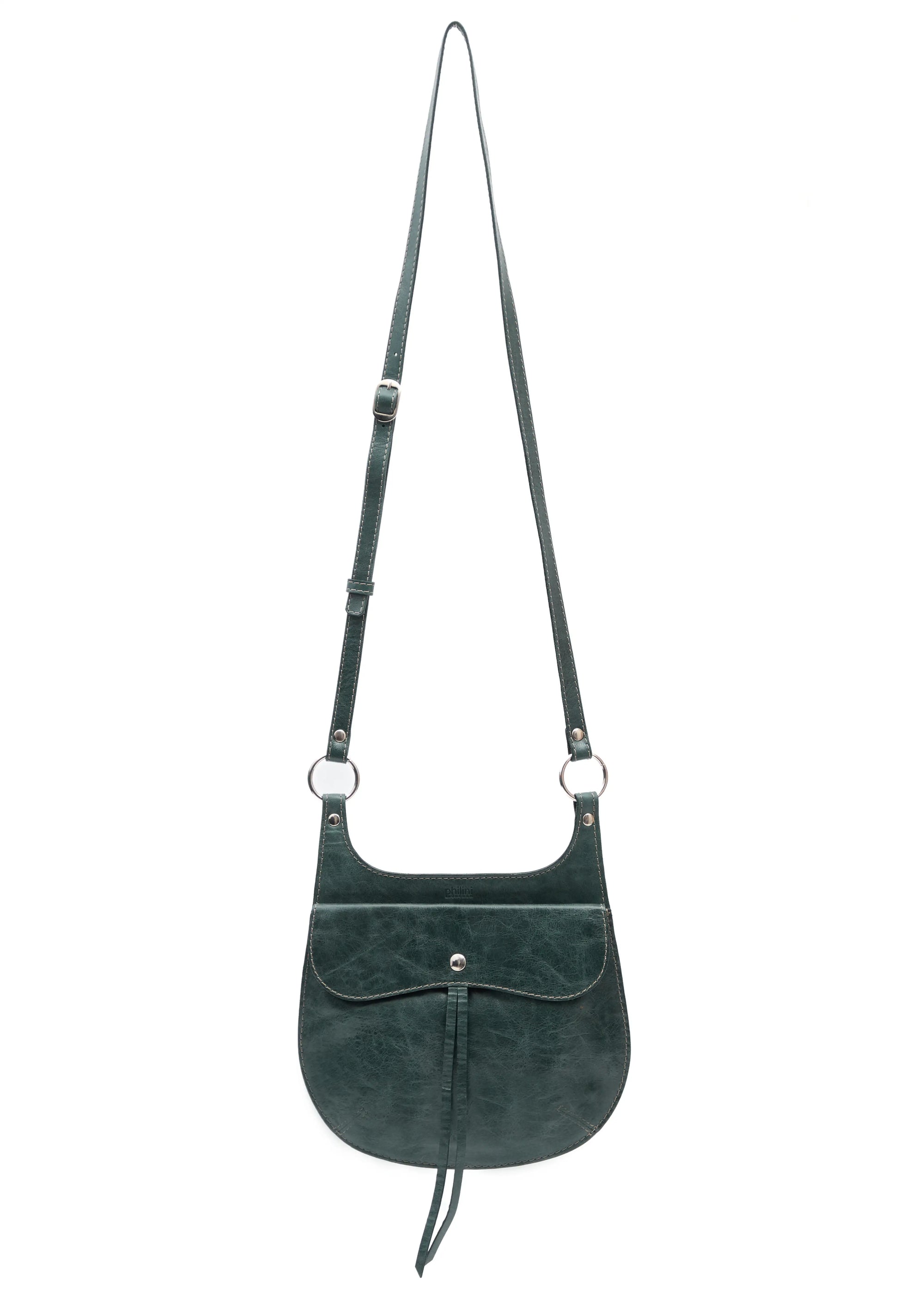 Front view of the Philini Cowboy Crossbody Bag in dark green calf leather, rounded saddle silhouette with front flap, snap closure, and long adjustable strap. Elegant mini leather crossbody bag