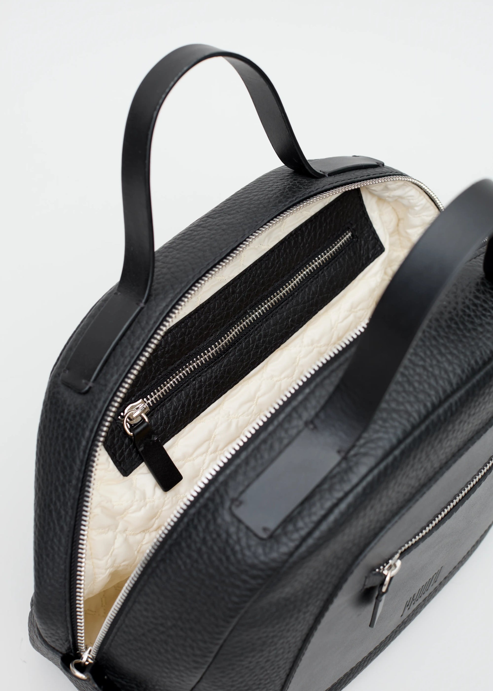 Interior view of the Philini  Handbag, showcasing hand-stitched full-grain leather handles,