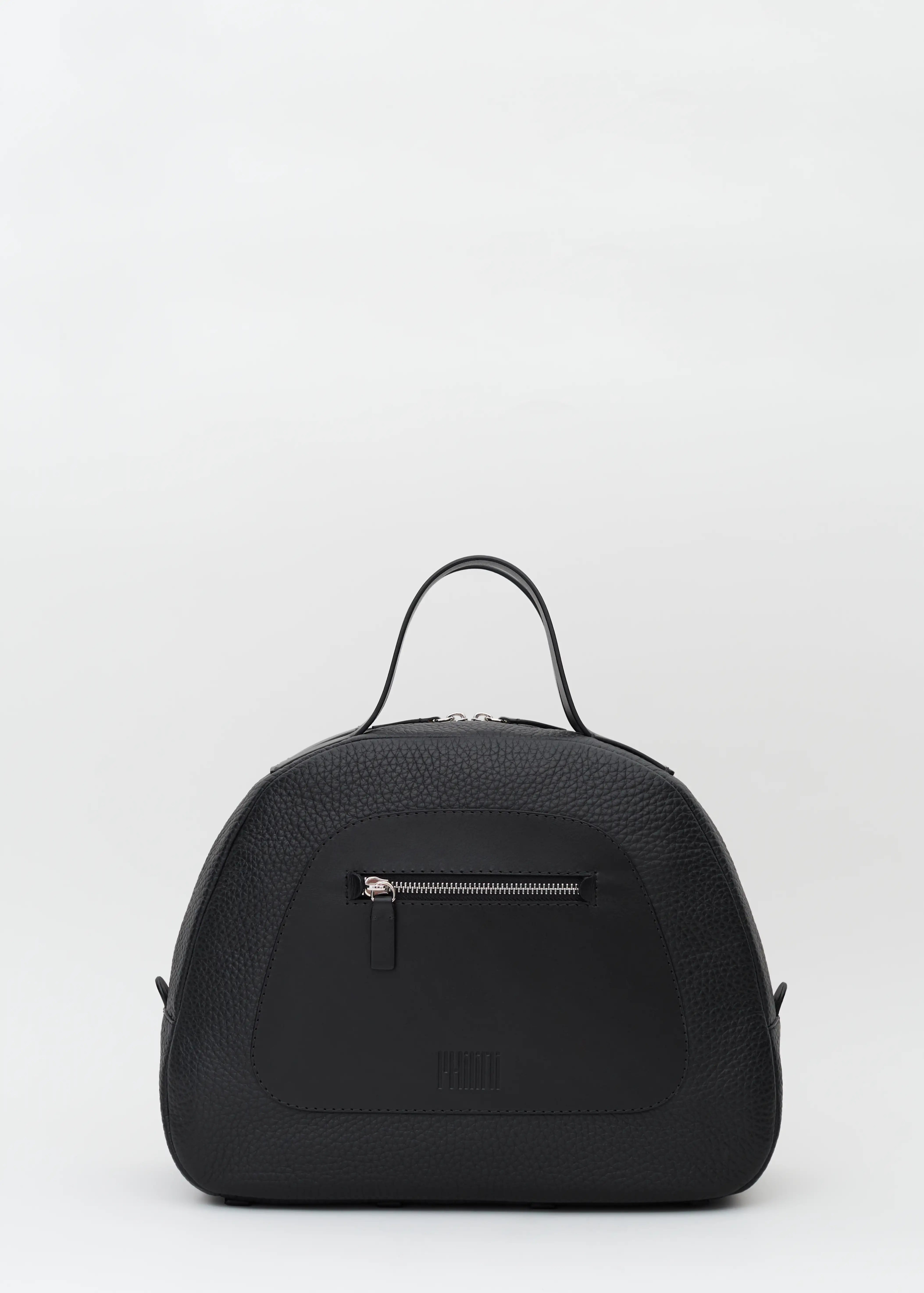 Front view of the Philini Domi Black Dome Handbag, crafted from black buffalo leather with a full-grain leather zip pocket, short handles, and silver rivets and zipper. This handcrafted luxury leather bag is a timeless accessory. 