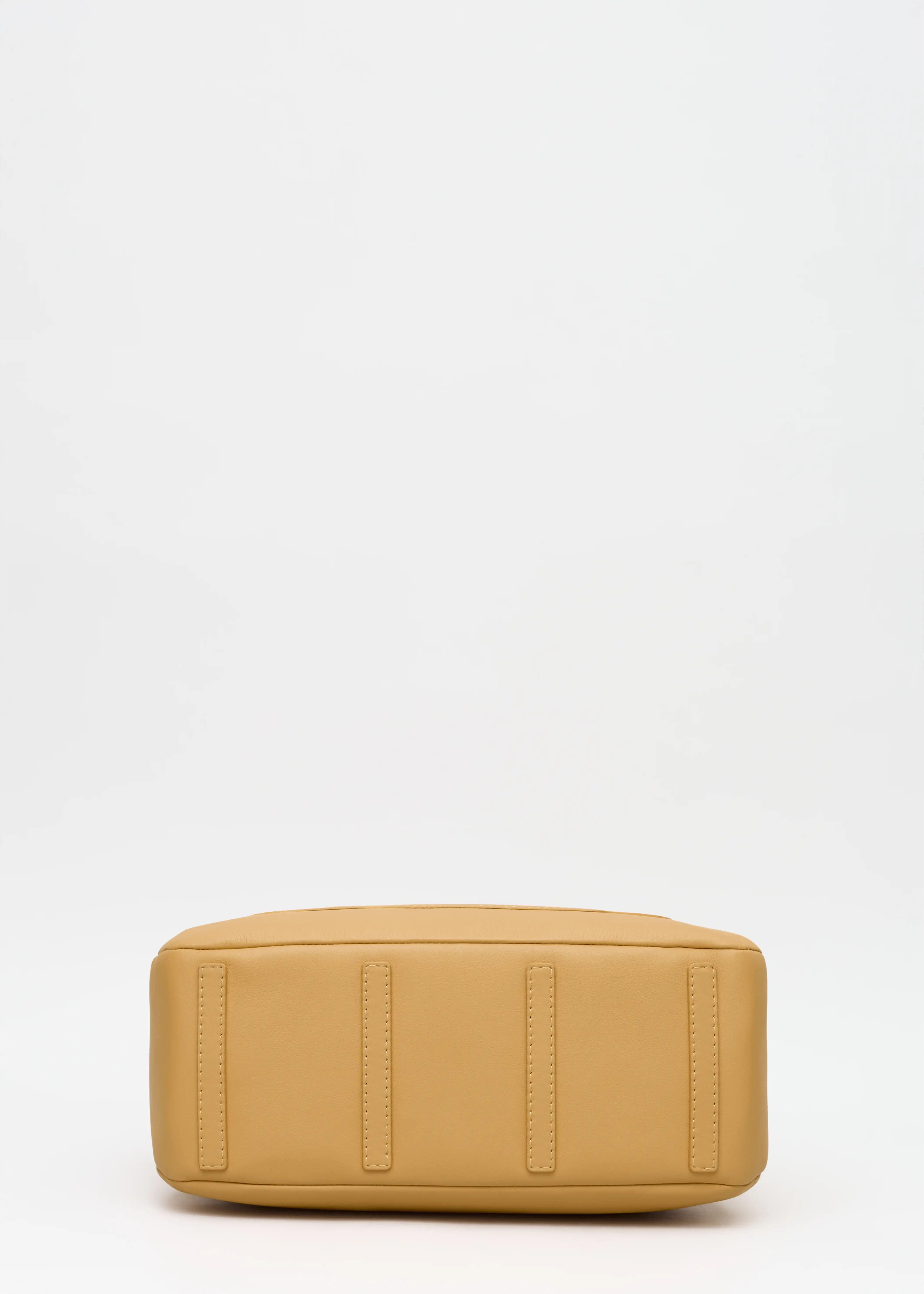 Bottom view of the Philini Domi Handbag in yellow nappa leather, showing dome shape and leather protective feet. Handmade luxury bag with classic style and eco-friendly craftsmanship.