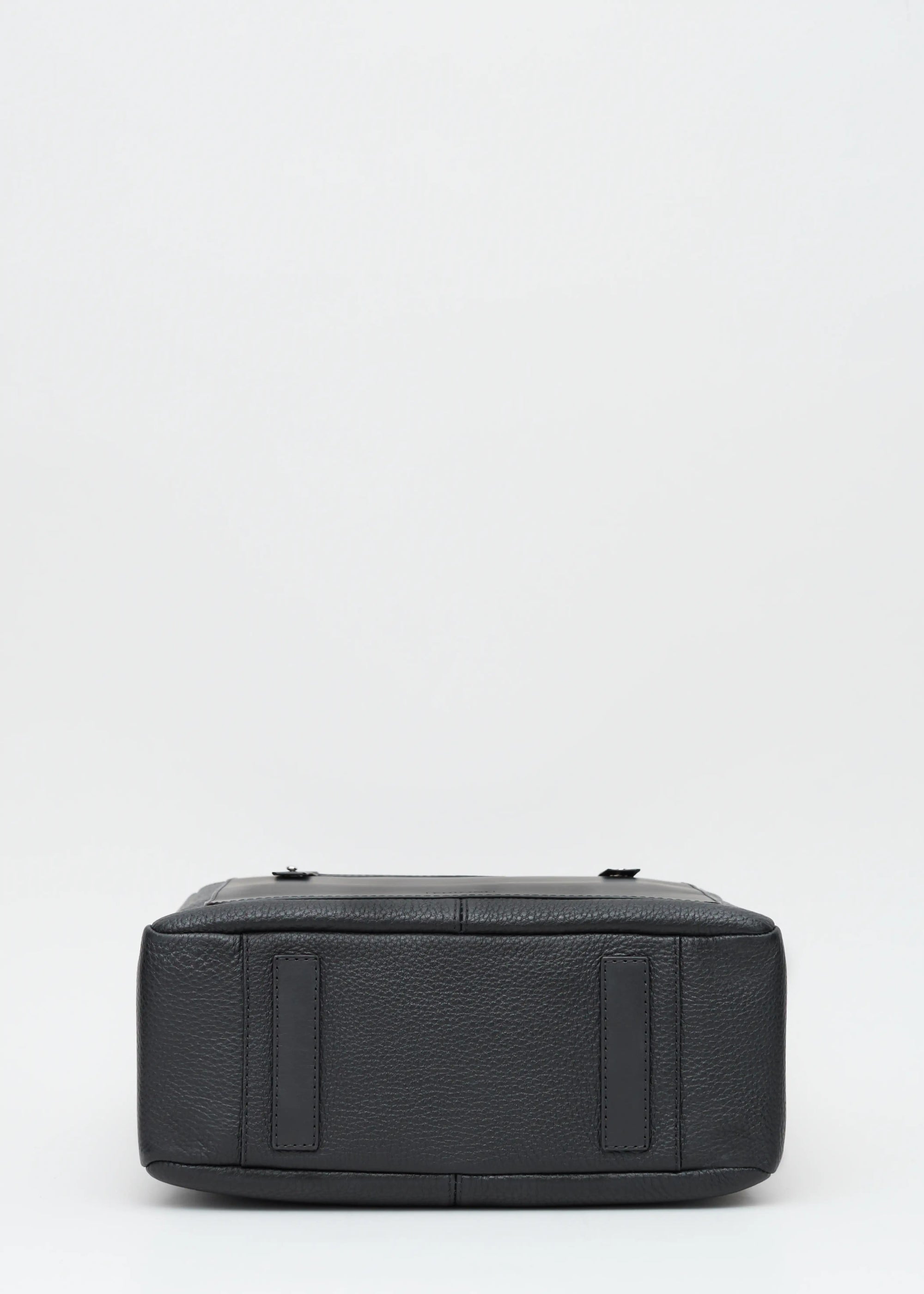 Bottom view of the Philini Elena Black Tote Bag, showing two protective leather pads as bottom feet, crafted from premium  leather for durability and elegance