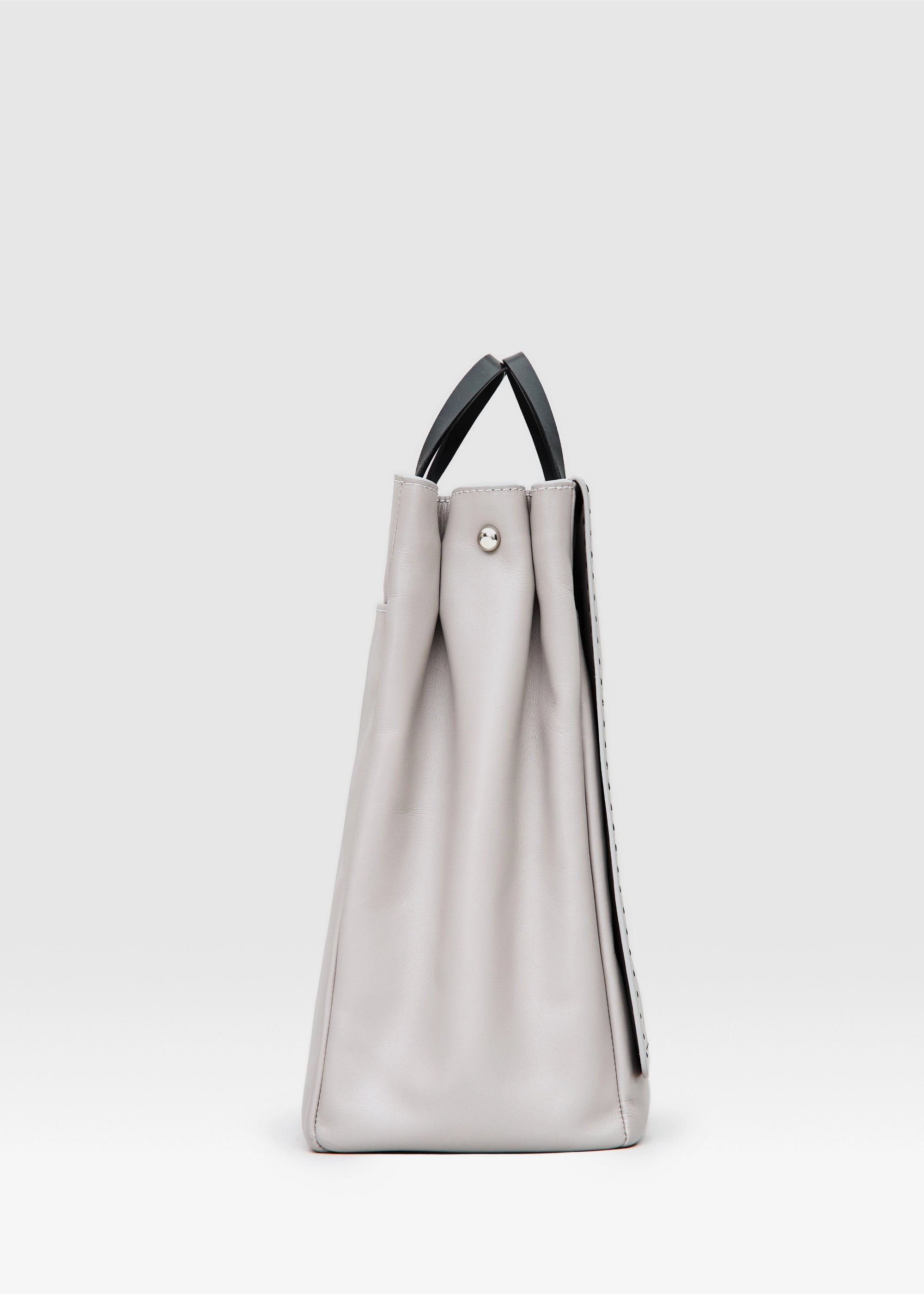 Profile view of the Philini Kathy Taupe Business Bag in aniline calf leather with flat handles and front flap pocket