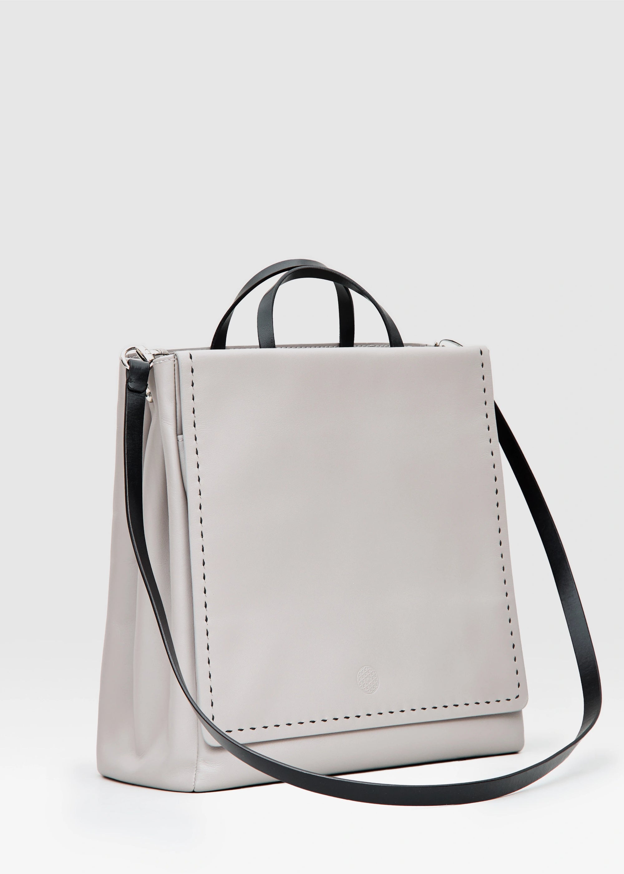 Side view of the Philini Kathy Taupe Business Bag in aniline calf leather with flat handles and front flap pocket