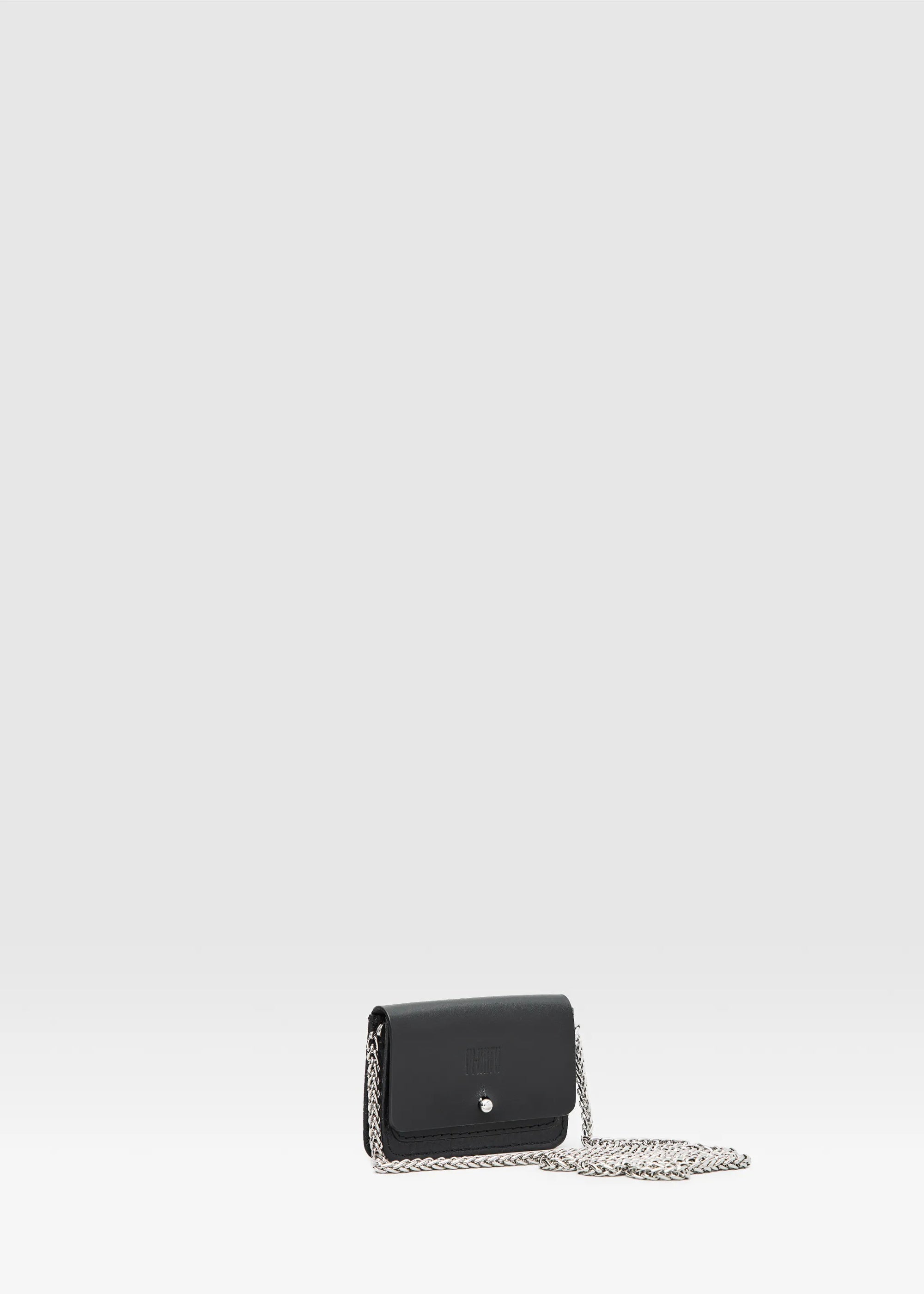 Front-up view of the Philini Lea Black Business Card Holder with the flap open and chain, showing a silver cufflink closure and small exterior pocket. Crafted from natural leather, this minimalist cardholder is handcrafted leather business accessory 