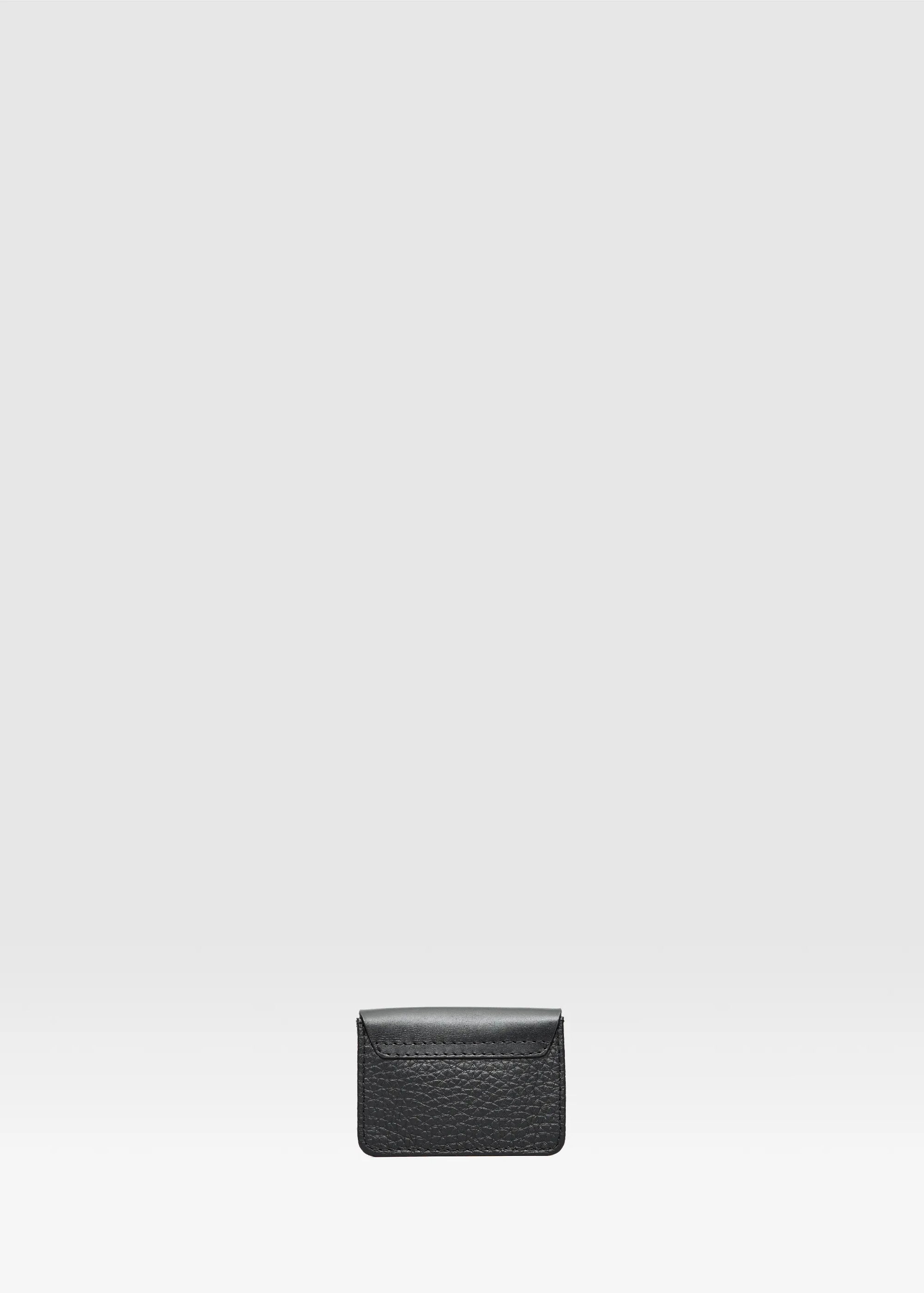 Back view of the Philini Lea Black Business Card Holder, showing seamless full-grain leather flap merging with buffalo leather base. A handcrafted, sustainable leather card wallet designed for business card organization