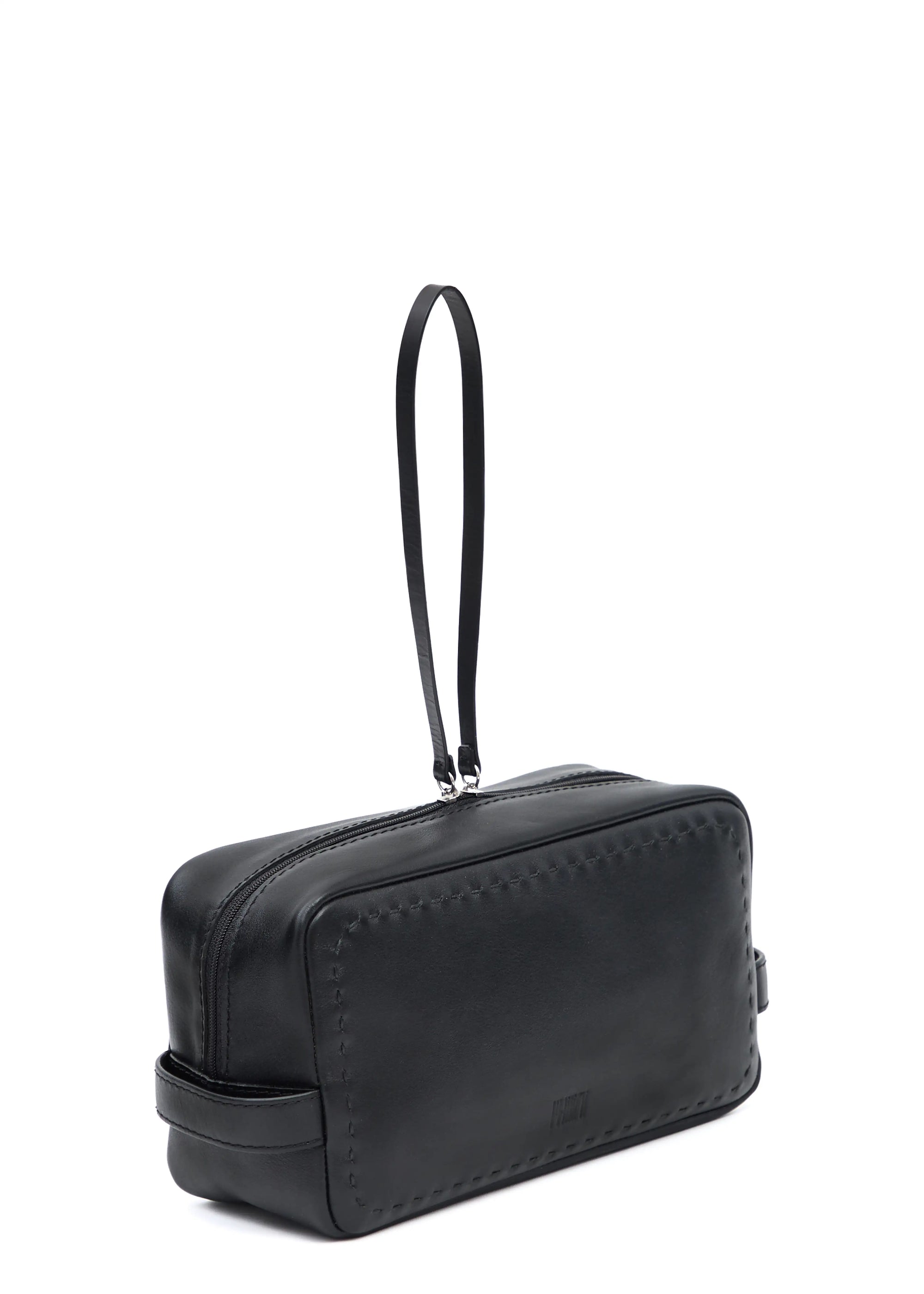 Side view of the Philini Magdalena Pouch in black leather, featuring short side handles, zip closure with leather pull, and hand-stitched edges. Sleek black cosmetic pouch, perfect as an everyday organizer or stylish accessory.