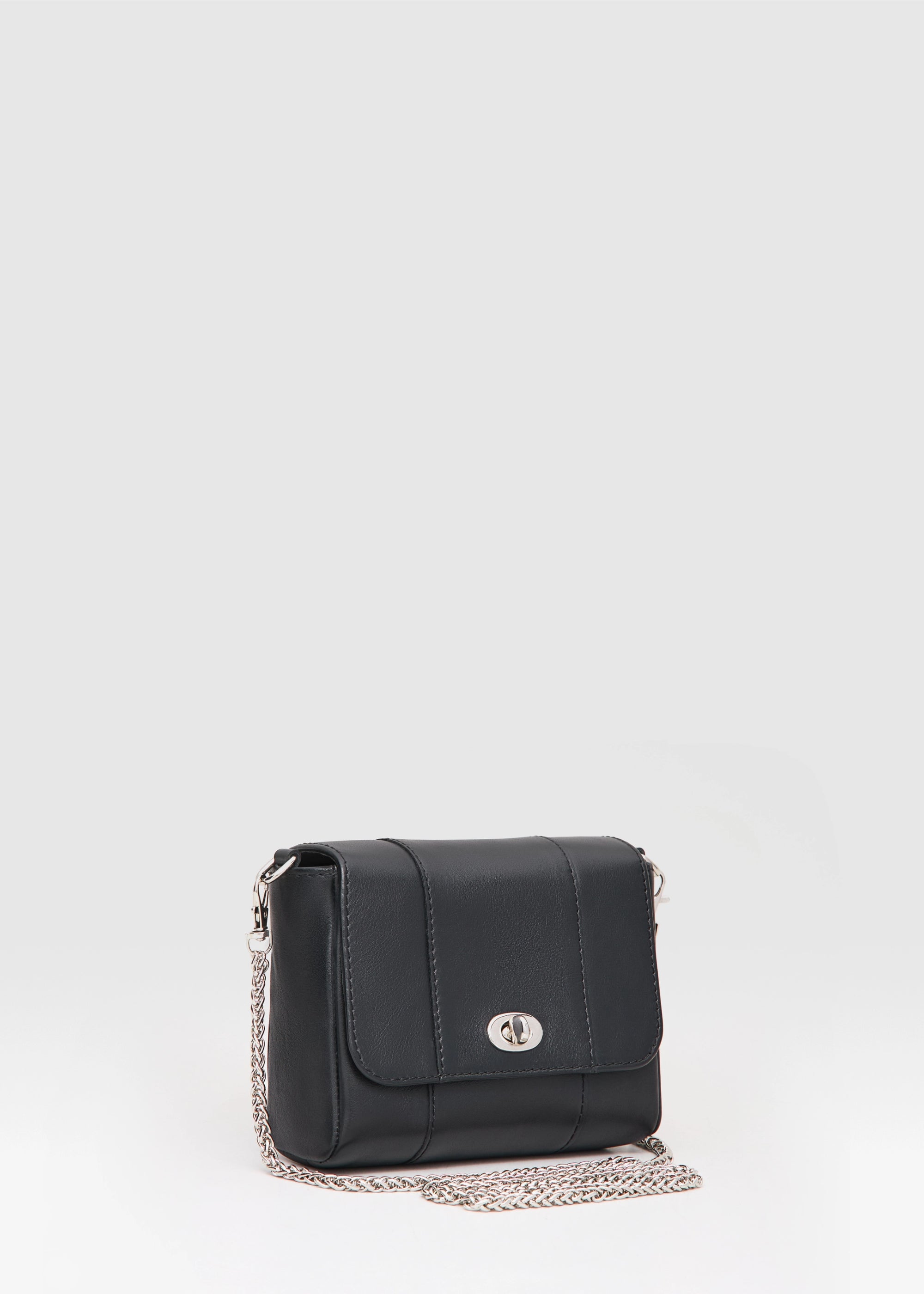 Side view of the Philini Marina Mini Crossbody Bag in black calf leather.Compact black leather purse