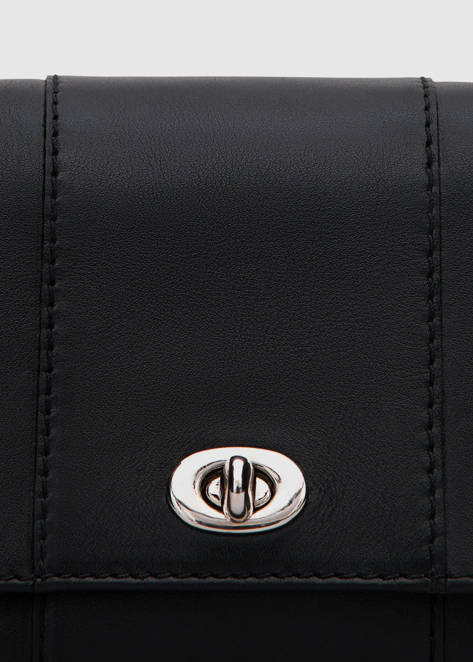 Close front view of the Philini Marina Mini Crossbody Bag showing front flap with silver clasp