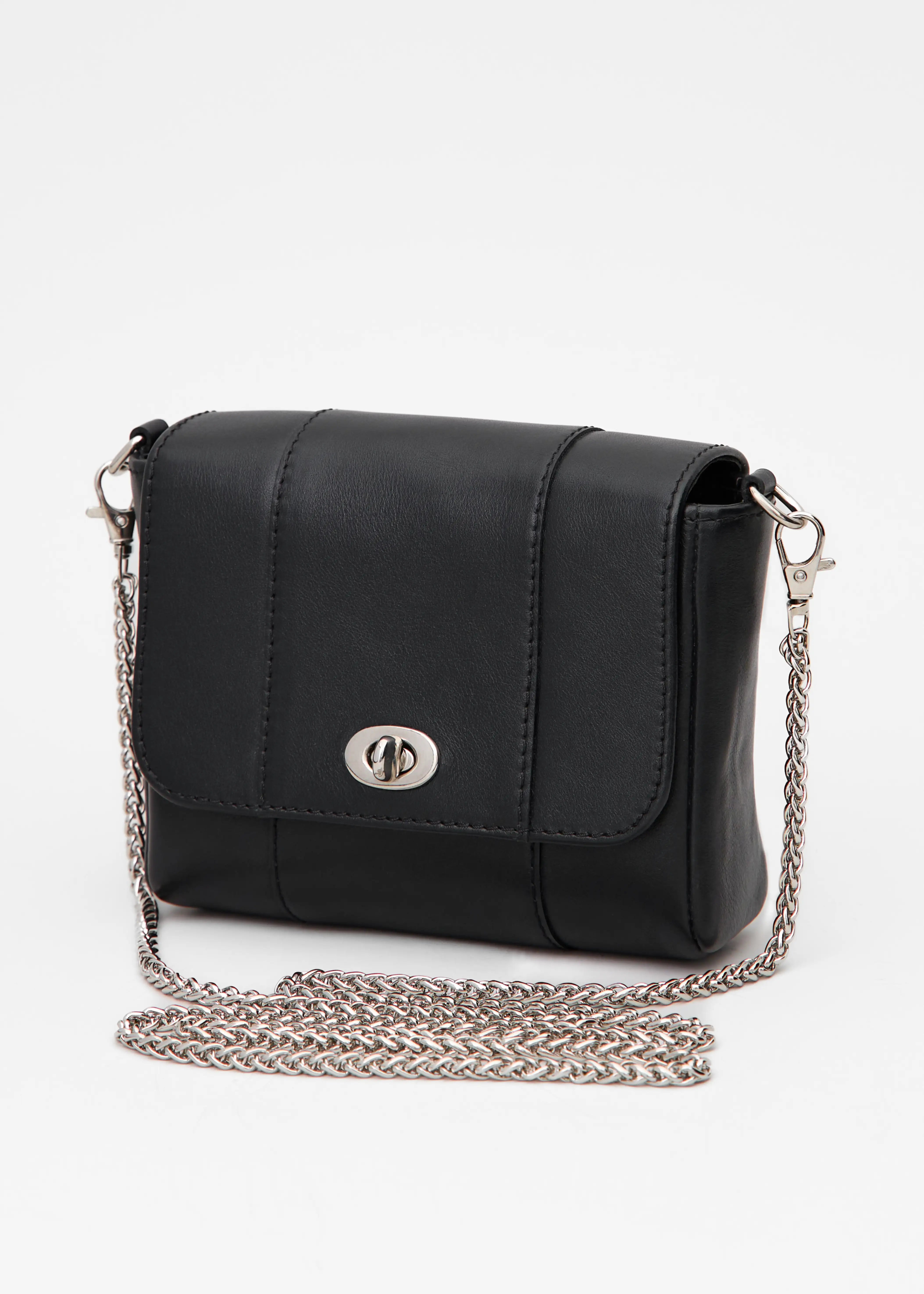 Side view of the Philini Marina Mini Crossbody Bag in black calf leather, rectangular silhouette with front flap, silver clasp, and shoulder chain. Compact black leather purse