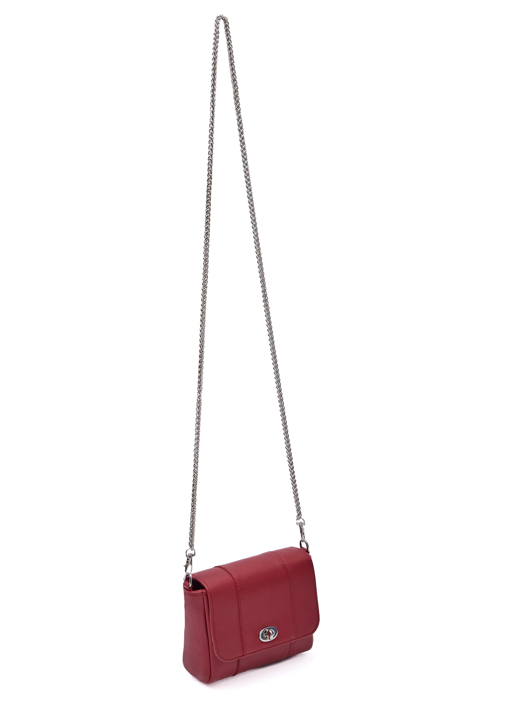 Side view of the Philini Marina Mini Crossbody Bag in red nappa leather, rectangular silhouette with front flap, silver clasp, and shoulder chain. Compact designer purse for women in bold red
