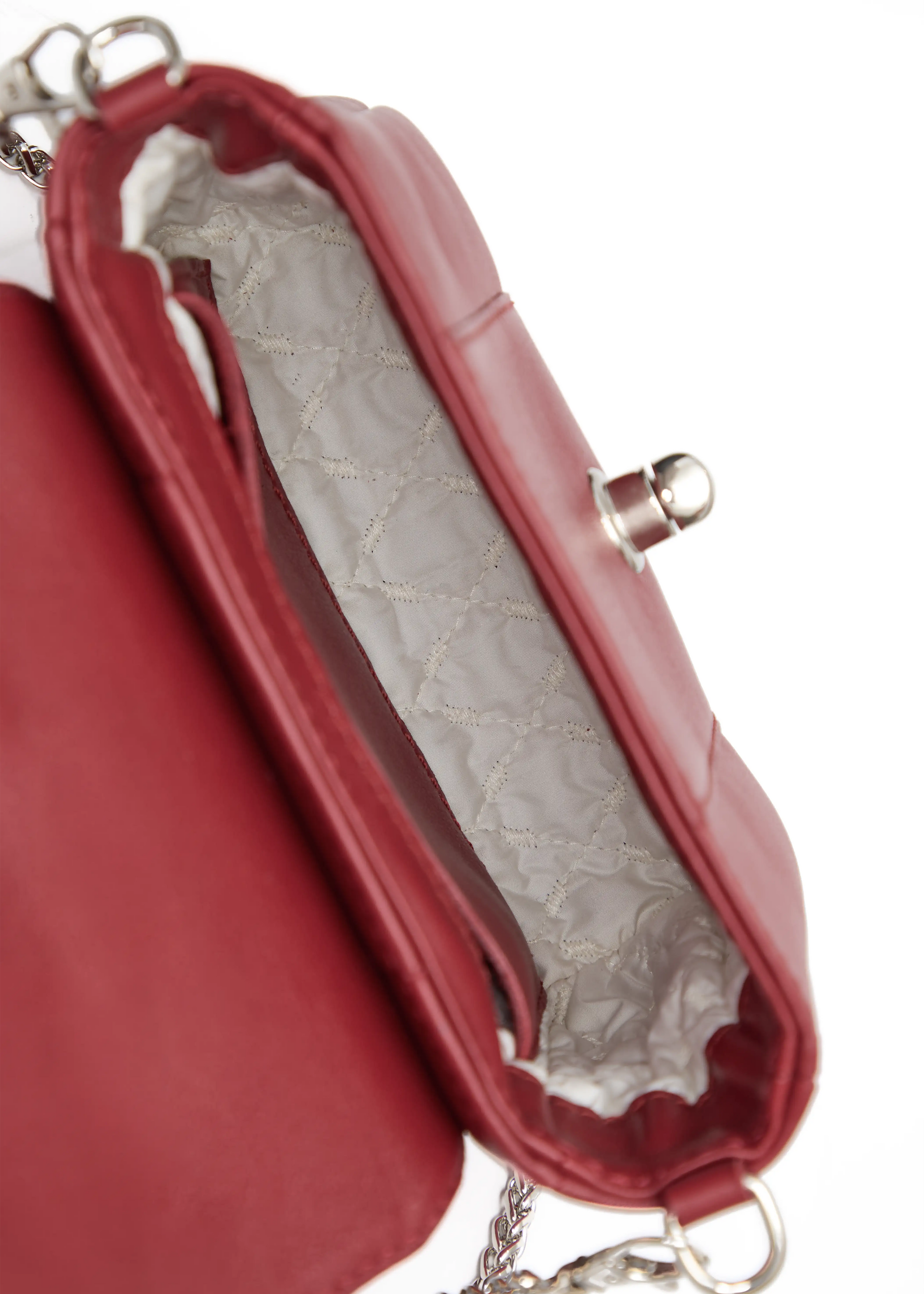 Inside view of the Philini Marina Mini Crossbody Bag in red nappa leather, showing open flap with silver clasp, chain with carabiner attachments, stitched vanilla lining, open compartment, inner pocket, and stamped logo. Stylish and functional red mini bag