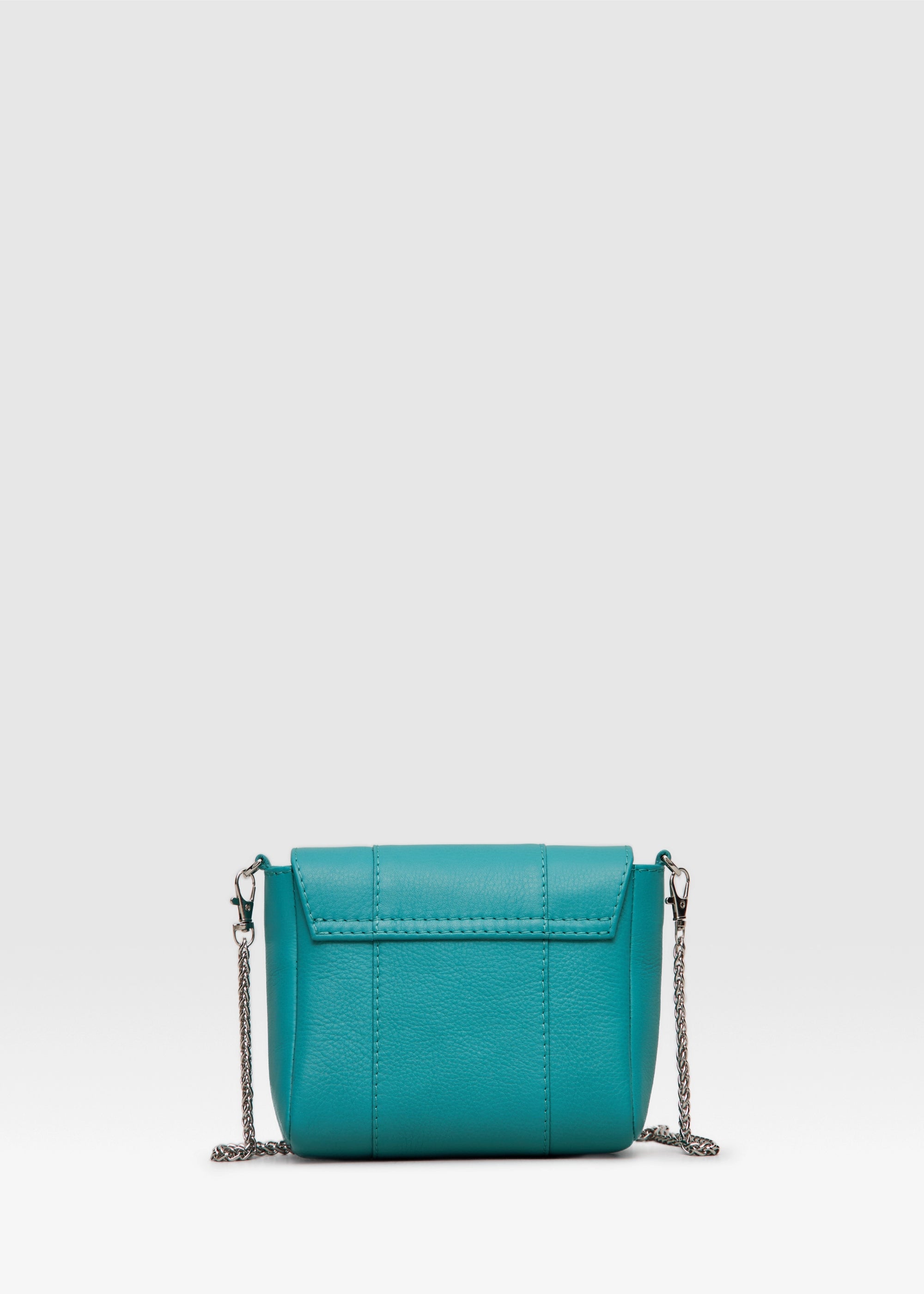 Back view of the Philini Marina Mini Crossbody Bag in turquoise calf leather, rectangular silhouette with front flap and silver chain shoulder strap. Handcrafted designer bag in a striking turquoise tone