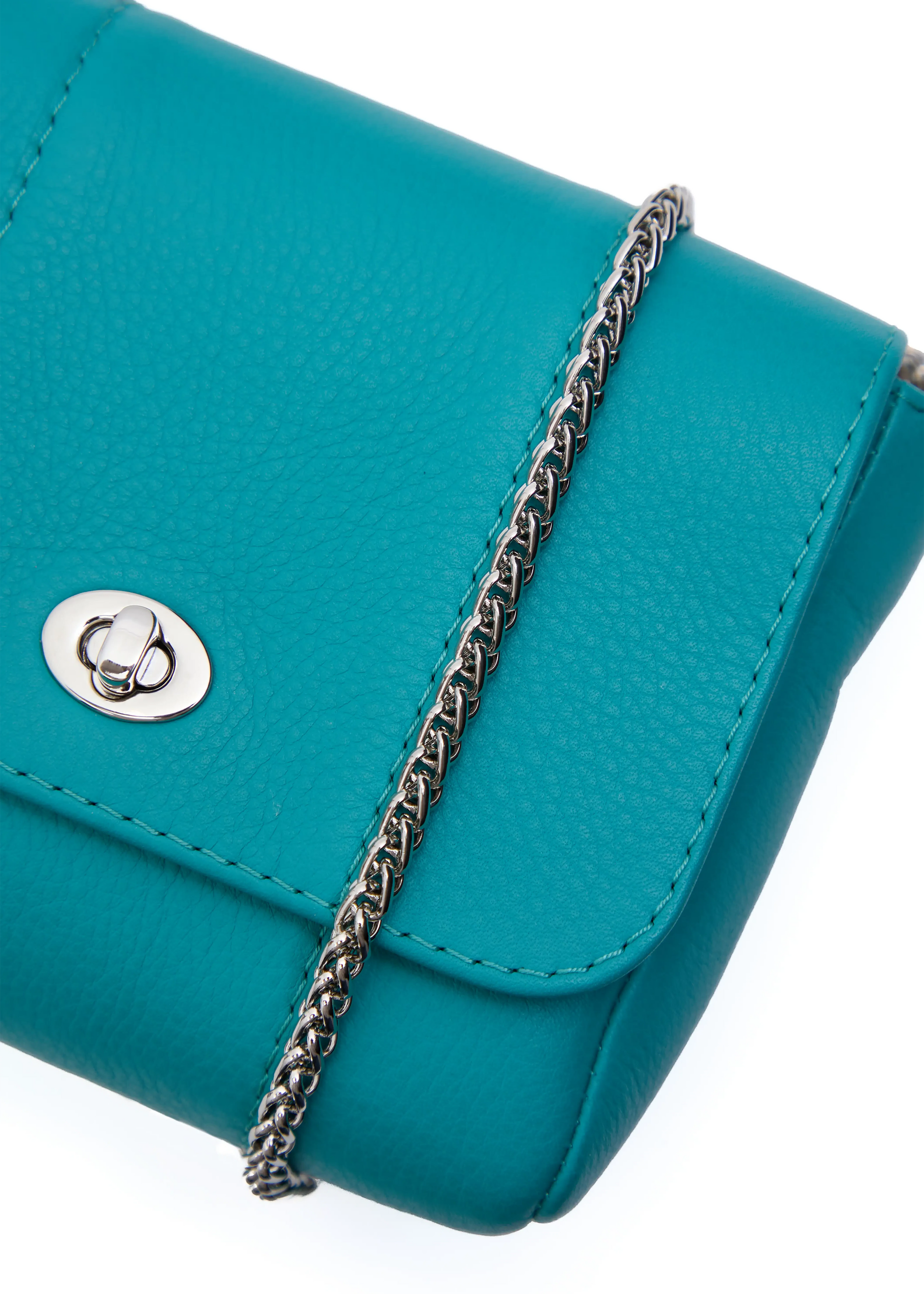 Close front view of the Philini Marina Mini Crossbody Bag in turquoise calf leather, showing front flap with silver clasp, silver chain, and detailed hardware. Crossbody bag with elegant, handmade detail 
